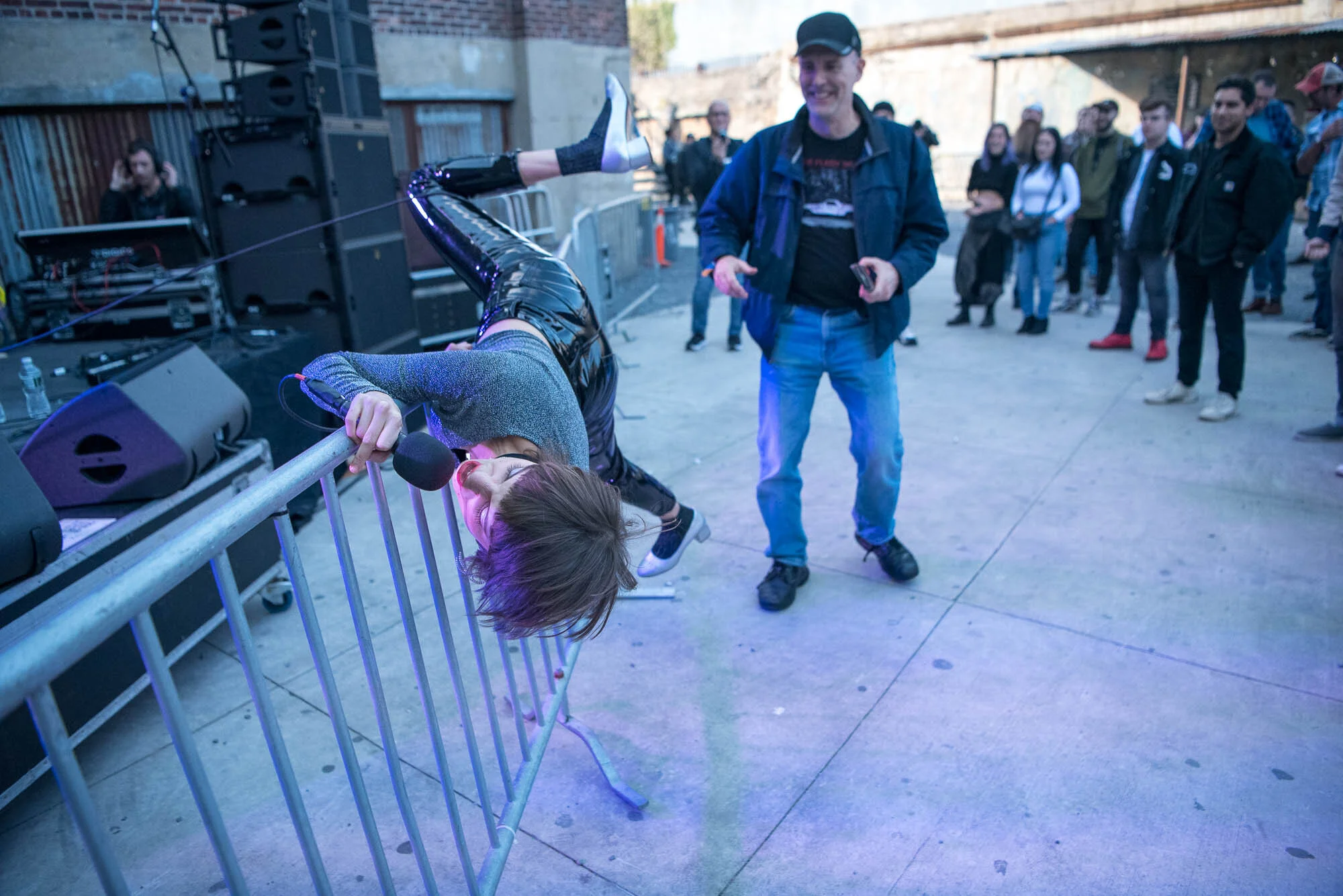 Ali Carter of Control Top climbs over the barricade during their performance at OctFest on Saturday, October 19, 2019.