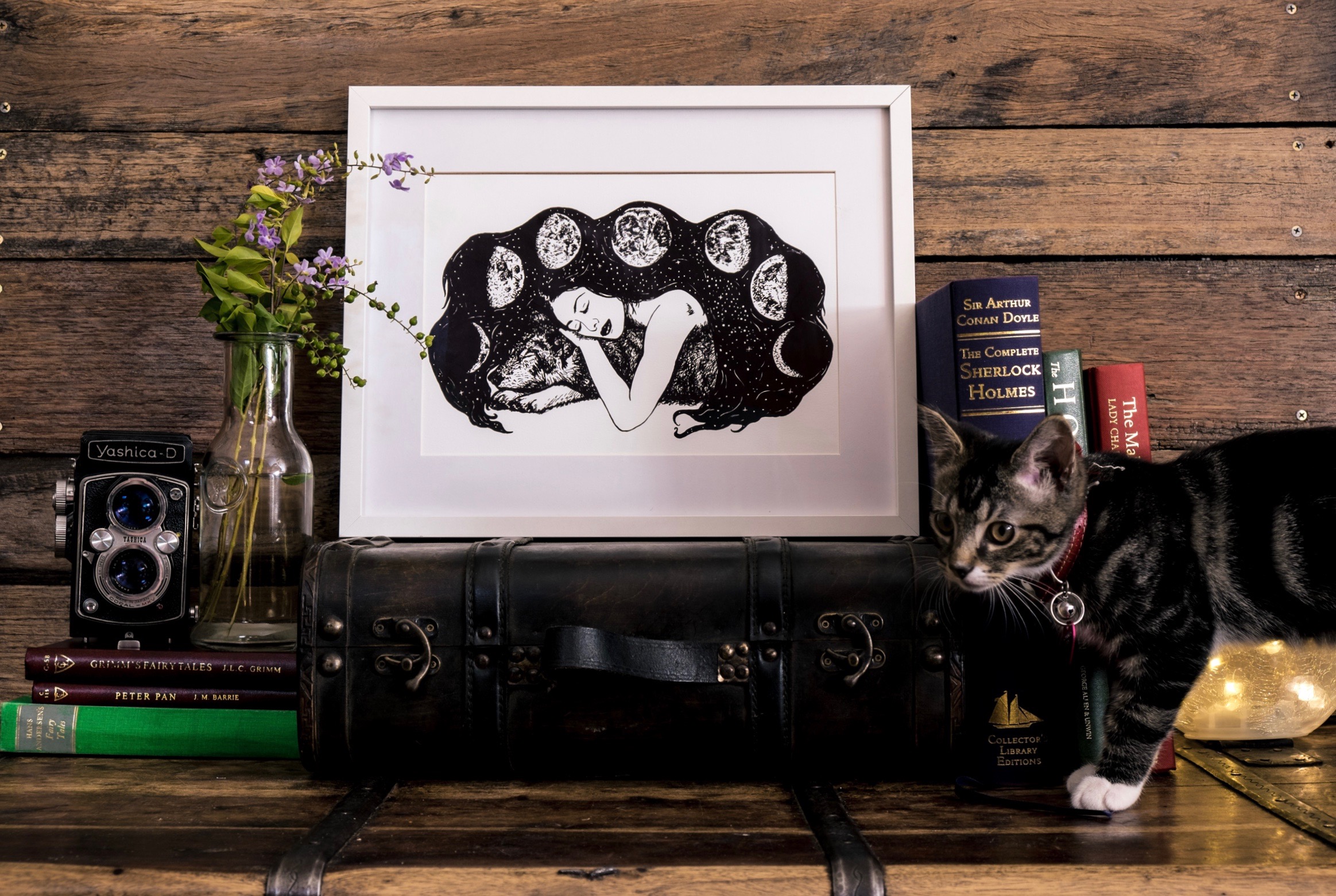 Behind the scenes of our photo shoot with its frequent kitten interruptions. Pictured is the Wolf and the Moon A4 print.