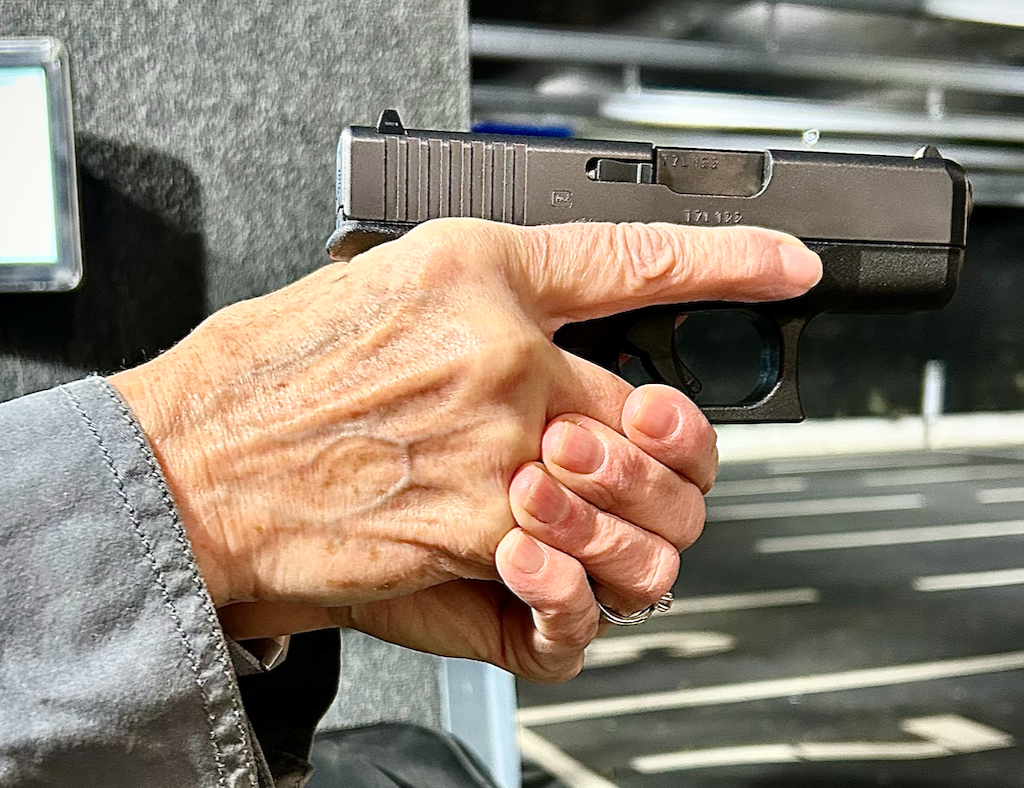 Ladies hands holding handgun.png