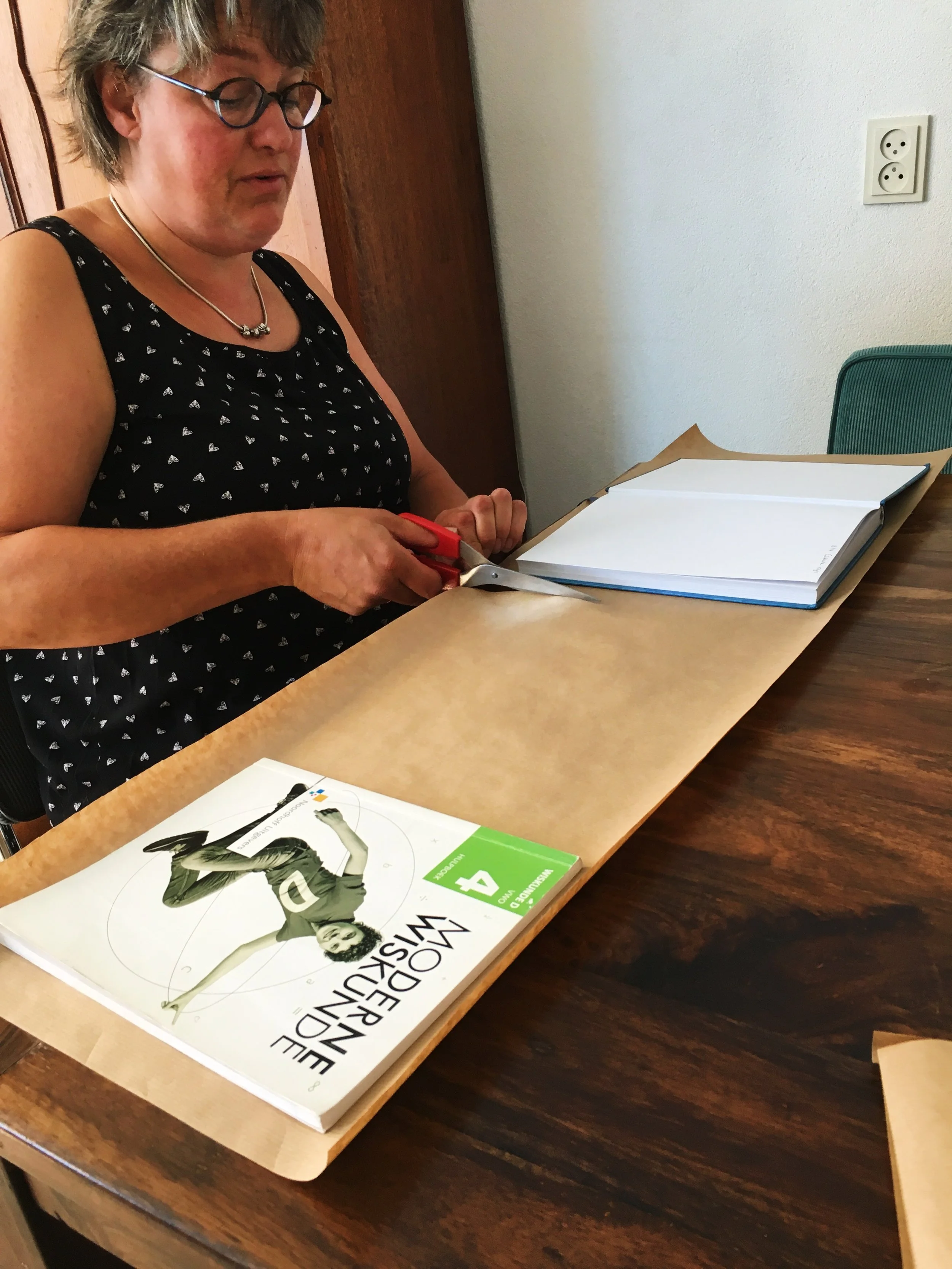 Petra teaching me how to cover my books!