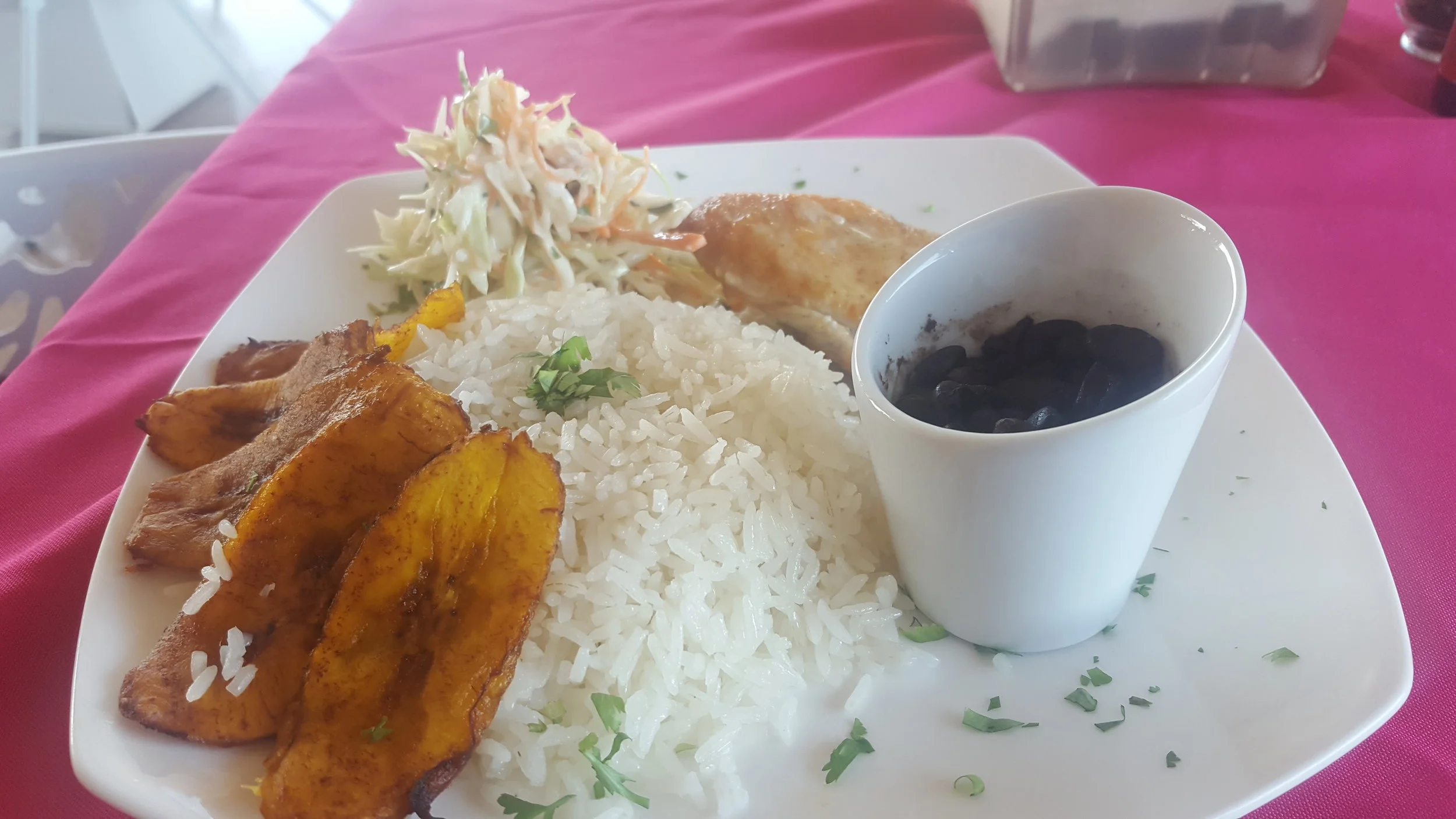 Traditional Costa Rican Meal. Rice, beans, plantain, coleslaw and grilled chicken.