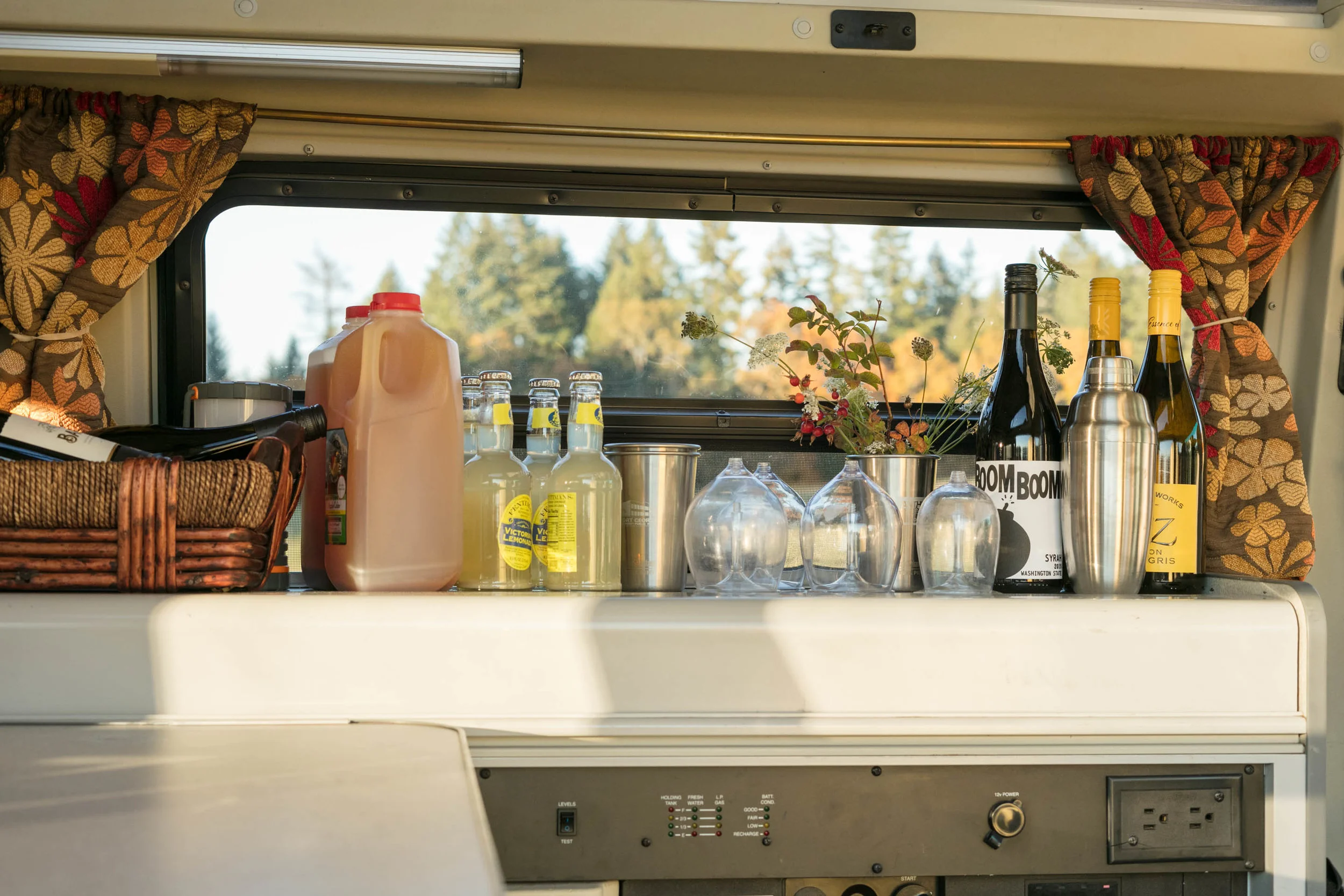 STEP 2: SET UP A BAR in one of your rented vans. This is the Rogue, a Eurovan Camper. We used the cover of the sink and stove to create a horizontal surface. Worked like a charm.