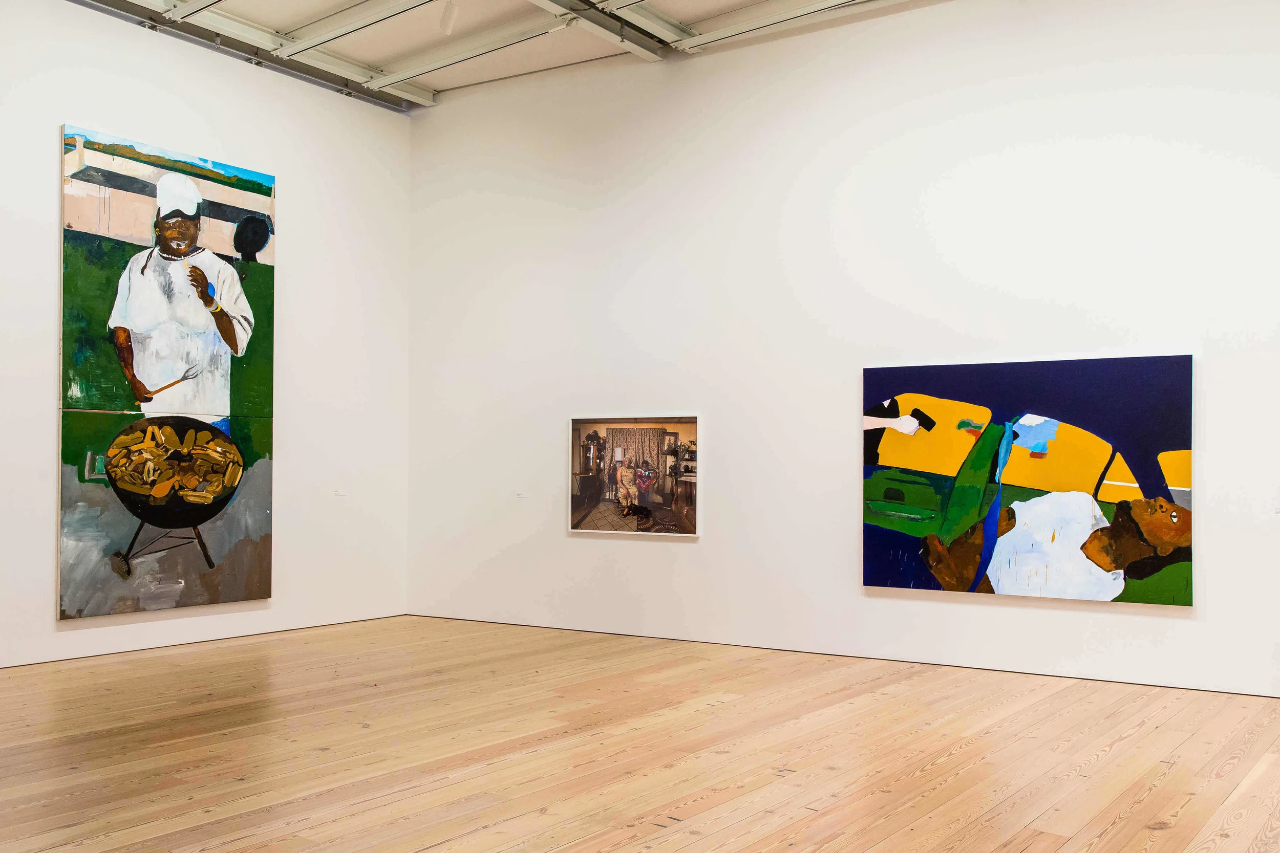Installation view of Henry Taylor, The 4th , 2012-2017 and THE TIMES THAY AINT A CHANGING, FAST ENOUGH!, 2017 , at the 2017 Whitney Biennial. Collection of the artist; courtesy Blum & Poe, Los Angeles/New York/Tokyo. Installation view of Deana Lawson, Ring Bearer , 2016, at the 20017 Whitney Biennial. Collection of the artist; courtesy Rhona Hoffman Gallery, Chicago, and Sikkema Jenkins & Co., New York. Photograph by Matthew Carasella, courtesy of the Whitney Museum of American Art.