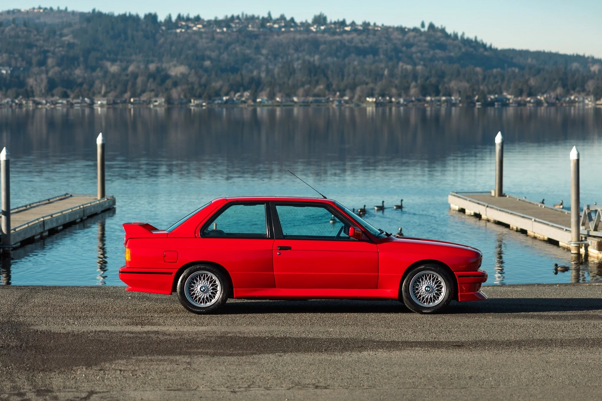 Meet our 1988 BMW M3, a legendary icon in automotive history! This meticulously restored beauty, boasts aggressive aerodynamics with wide fenders that were part of the DNA that was homologated in period for racing. Featuring a powerful 2.3L inline-fo