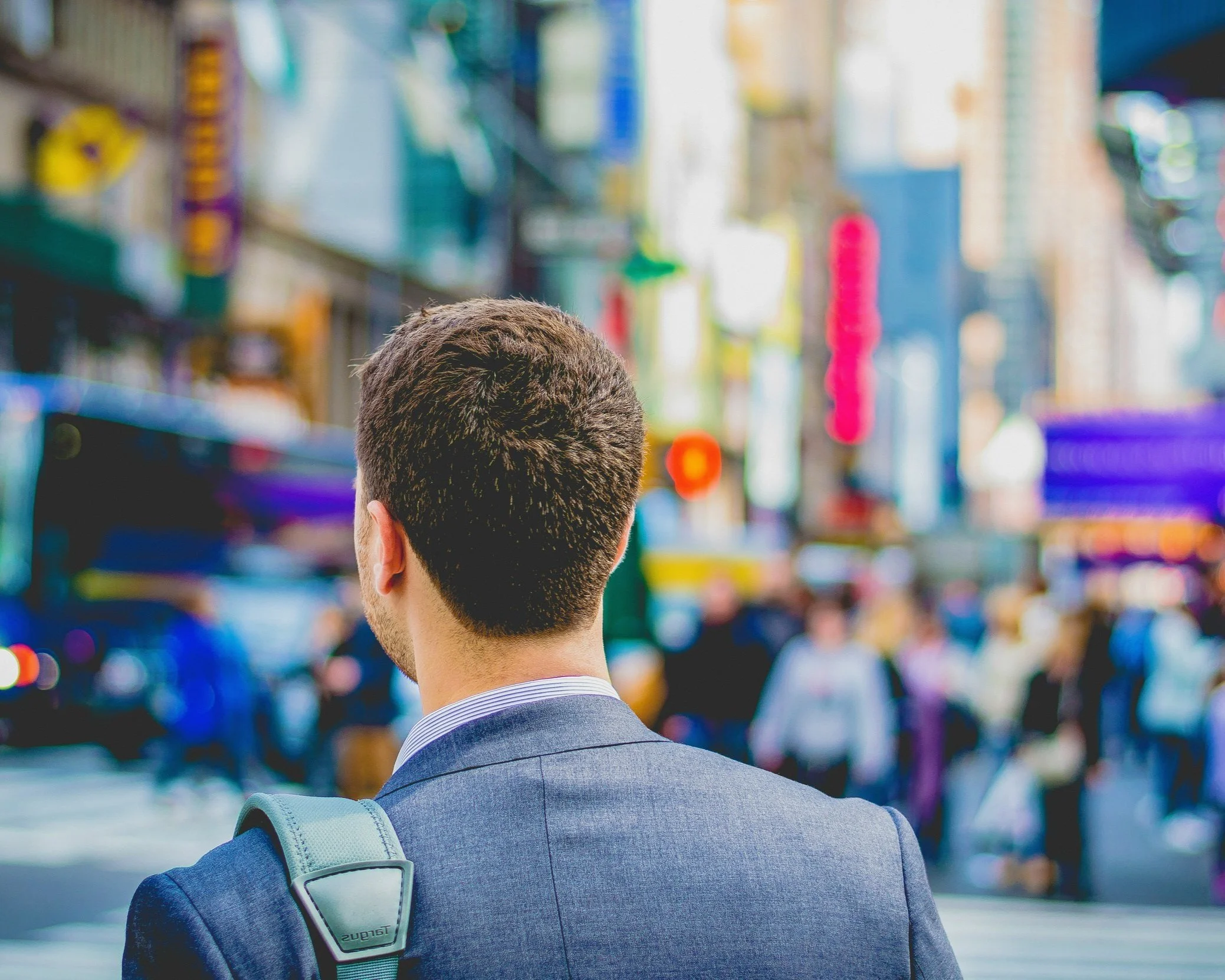 Man facing a New York Street. He is on his way to work.