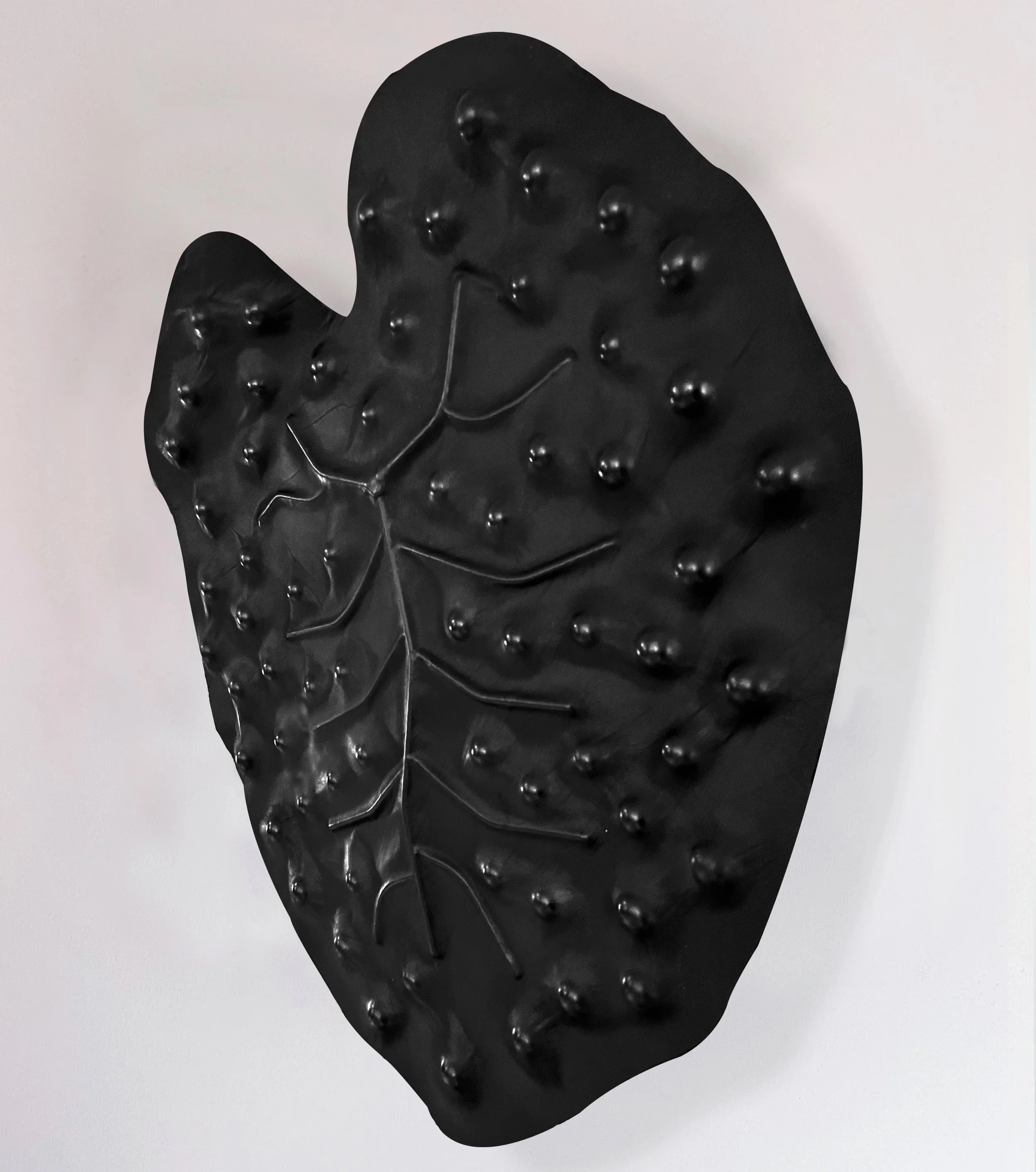Large, black, leather wall sculpture named Bubbled, created in 2026 by Madelon Uljee.