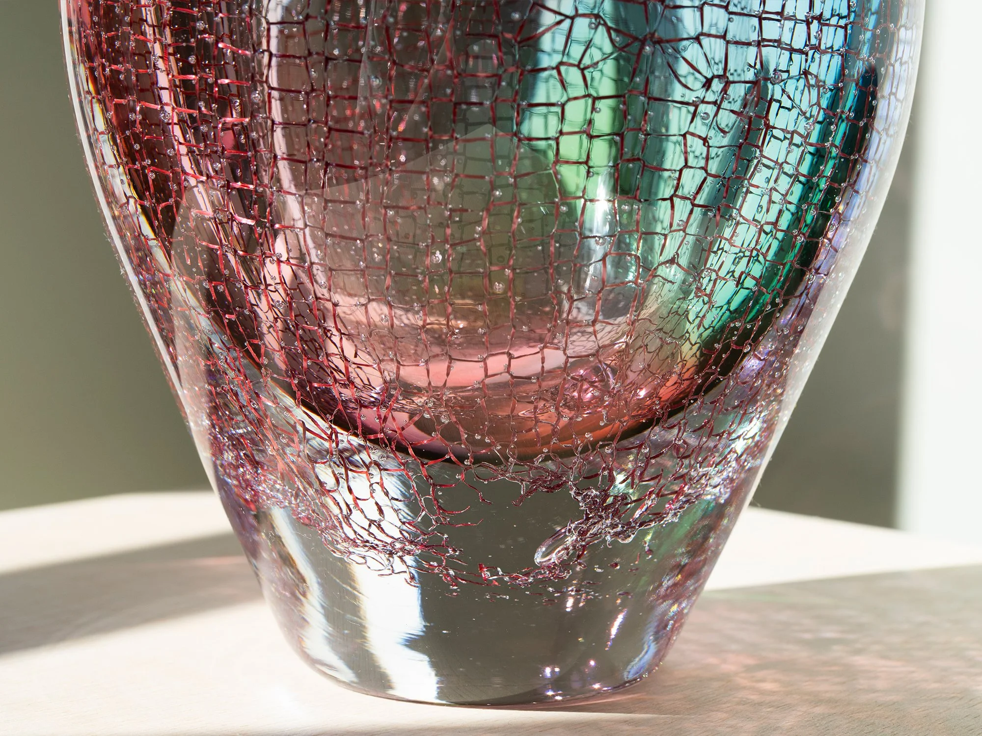 Detail of pink and green glass artwork by Francisca Snel viewed in natural light