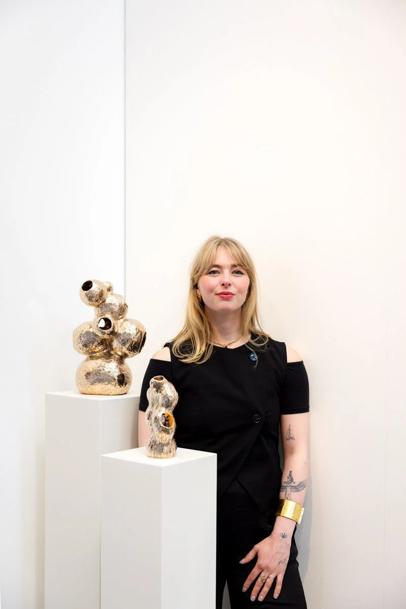 Artist Jeske Haak beside two of her contemporary bronze sculptures