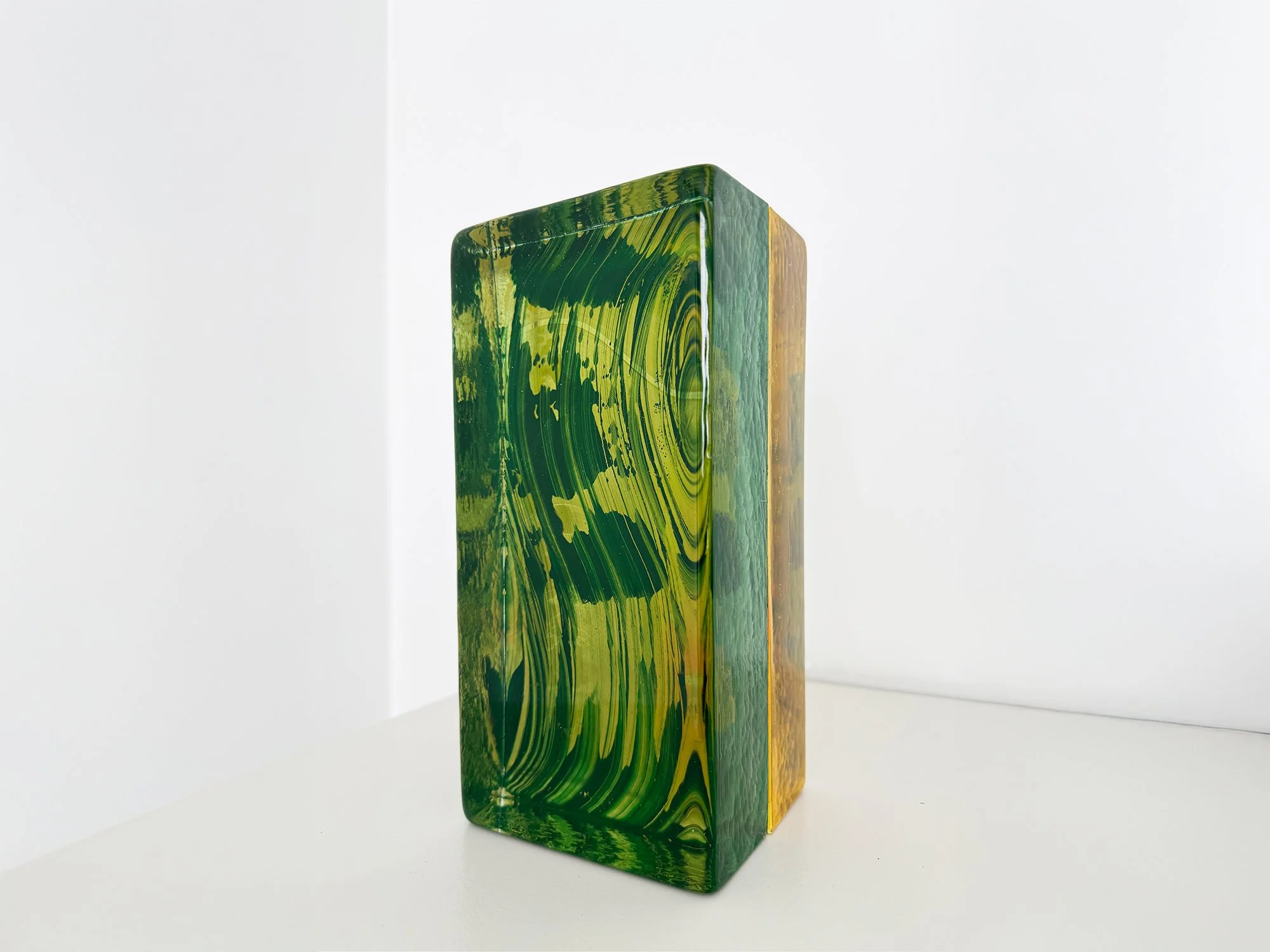 Lisette Schumacher, Spatial Shade III, 2025, cast glass sculpture in green and yellow tones on white table