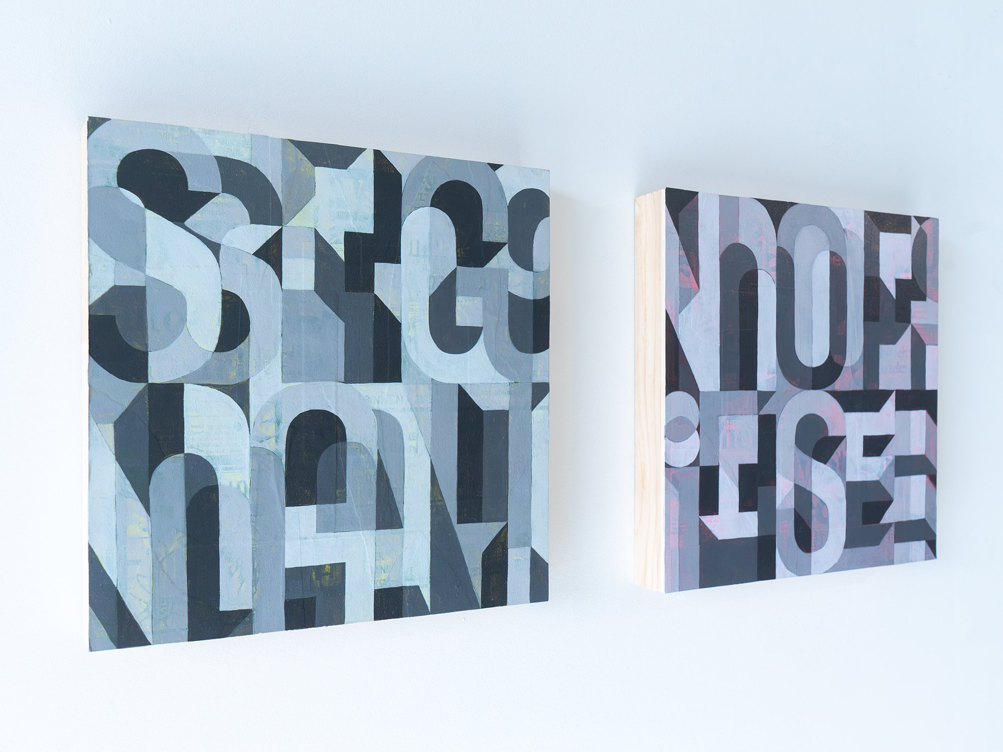 Angled gallery view of Signal and Noise, showing their contrasting blue-grey and muted pink palettes.