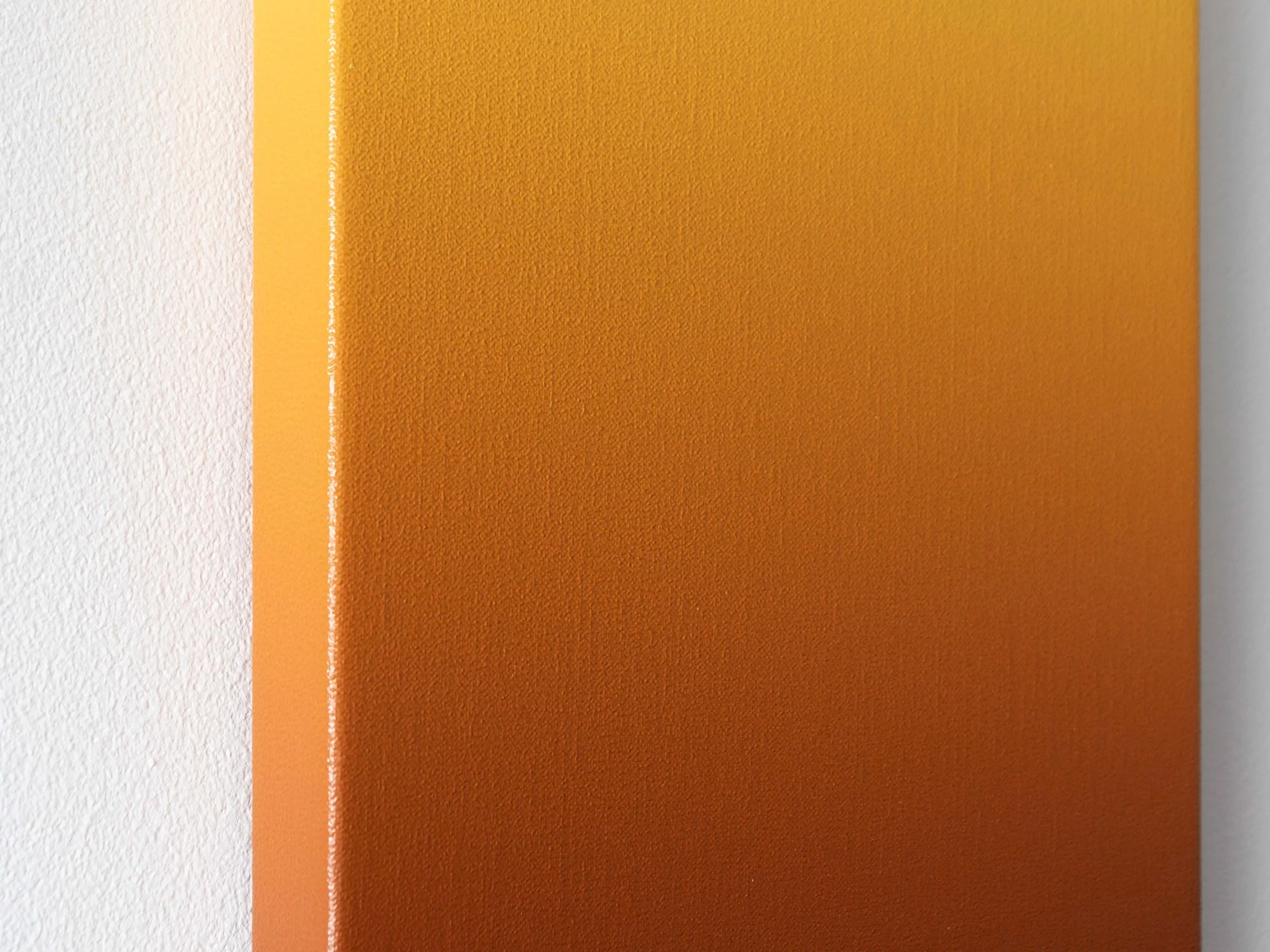 Detail close-up of Donald Schenkel’s Light Ochre painting, showing the fine texture of the linen and the smooth transition from golden yellow to warm ochre tones.
