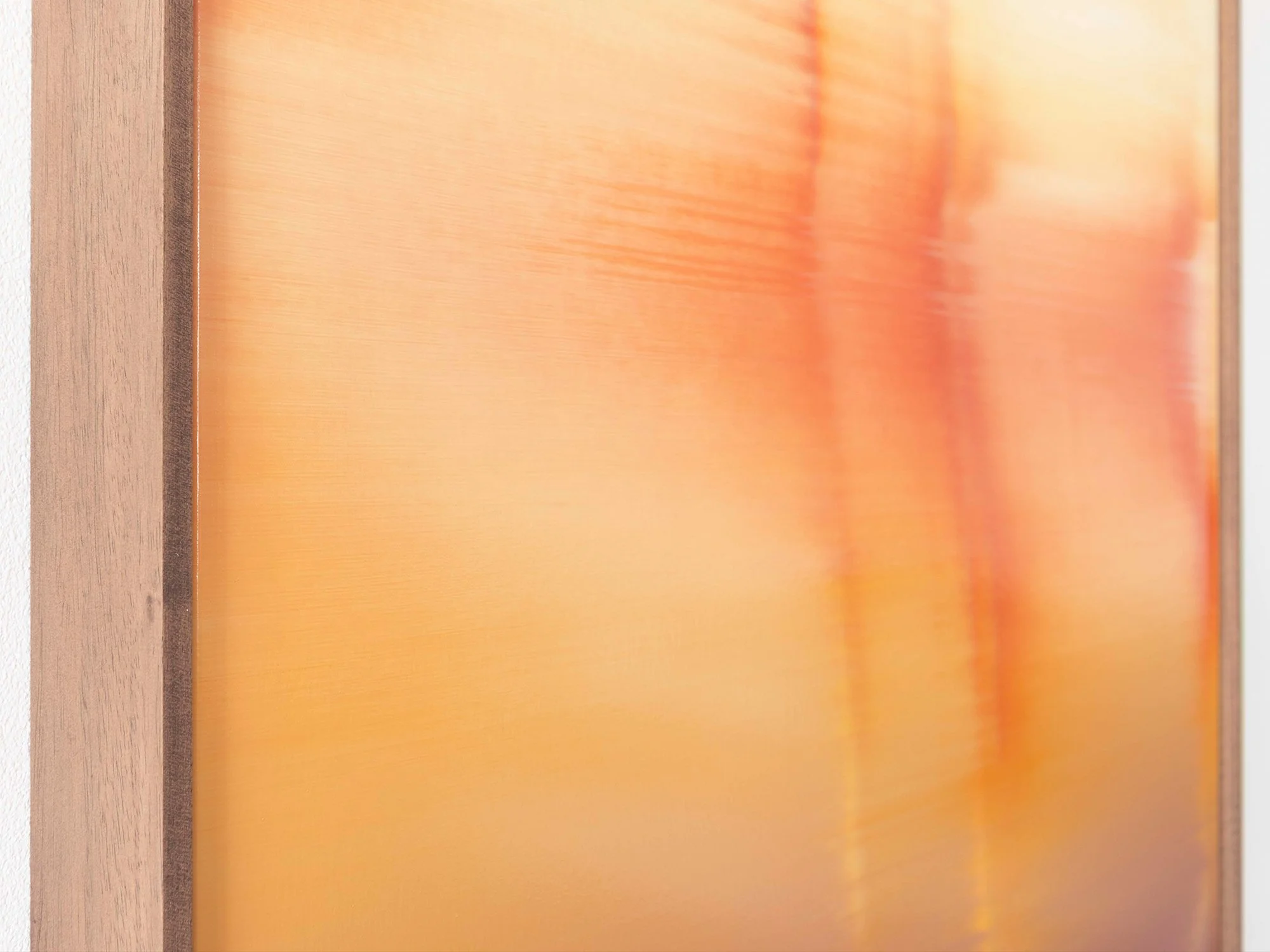 Detail of the walnut frame of Donald Schenkel’s “Unexpected Guest,” highlighting the warm wood grain surrounding the oil painting on canvas.