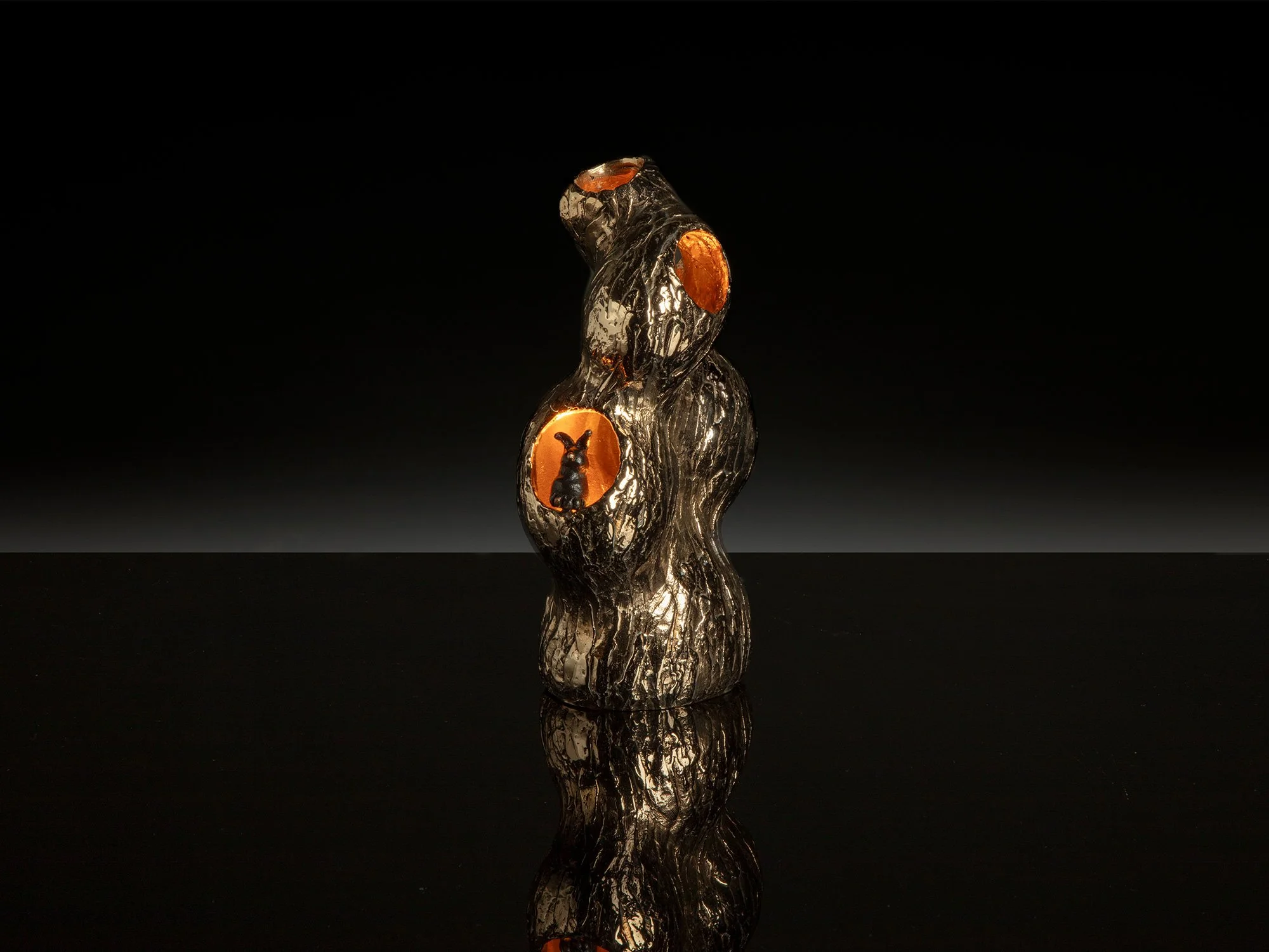 Bronze sculpture “The Hole of the Rabbit” by Jeske Haak, polished bronze with patina and light fitting, 2023
