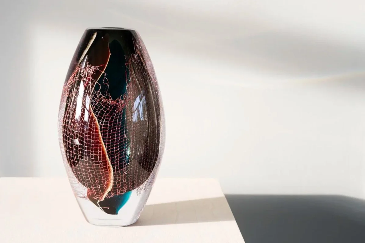 Crystal Clear #19 by Francisca Snel, a dark blown glass sculpture with copper mesh and deep red tones.