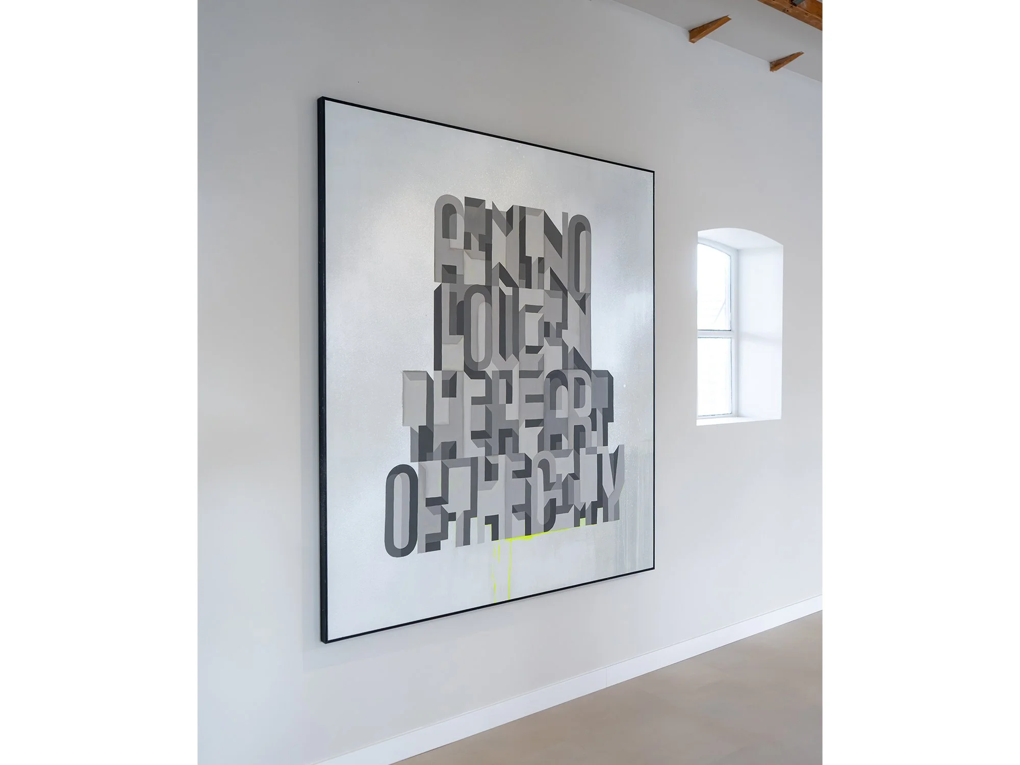 Side view of Saïd Kinos’s painting, showing the overlapping letterforms against its reflective silver ground.