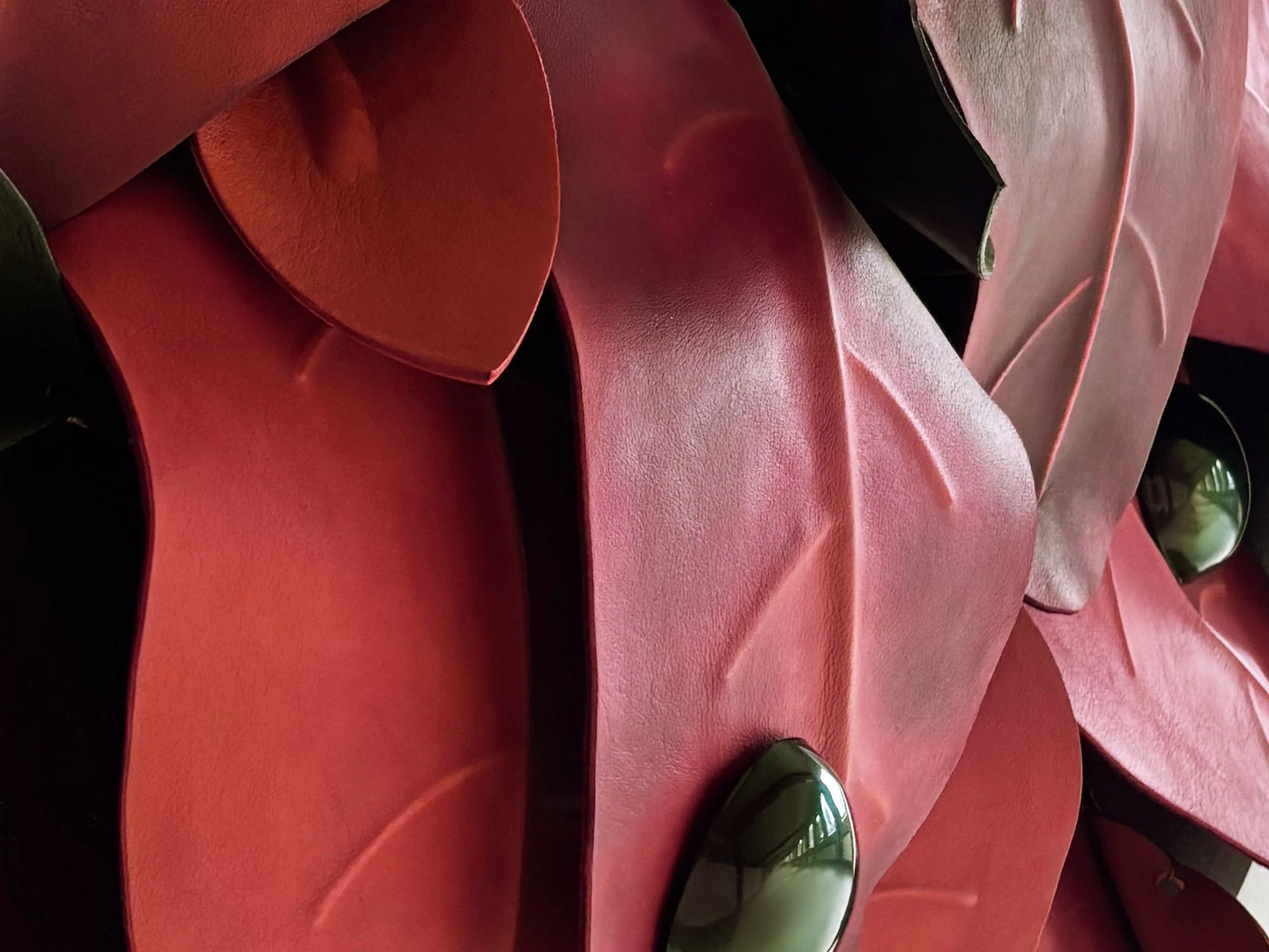 Detail of After the Storm by Madelon Uljee, showing the folds and texture of reclaimed leather shaped into leaves.