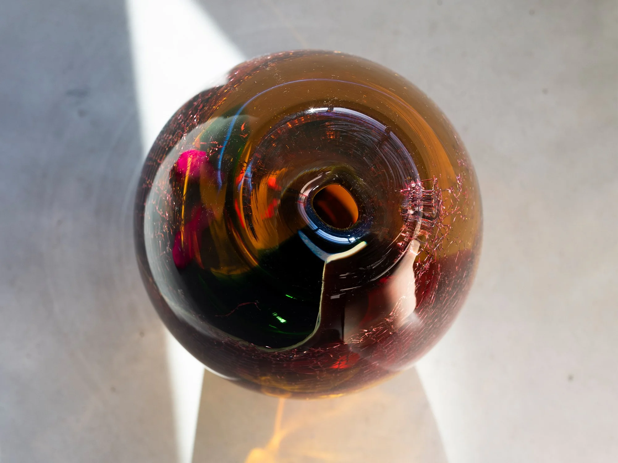 Top view of colourful glass and copper sculpture by Francisca Snel showing layered transparent glass