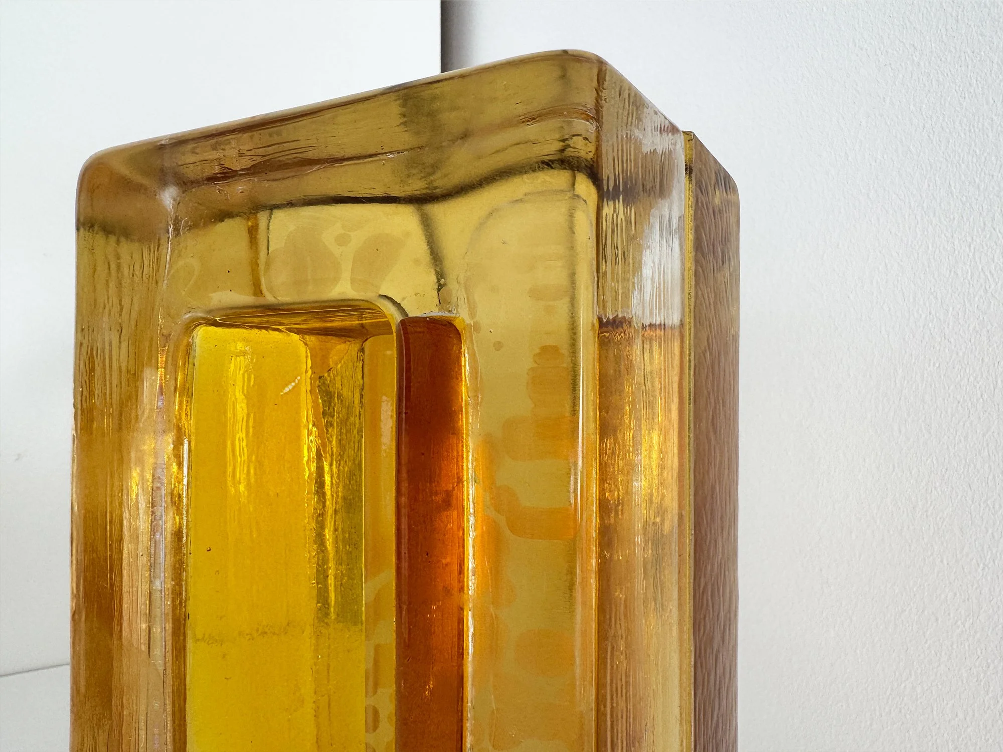 Detail of Lisette Schumacher glass sculpture in warm yellow and orange tones