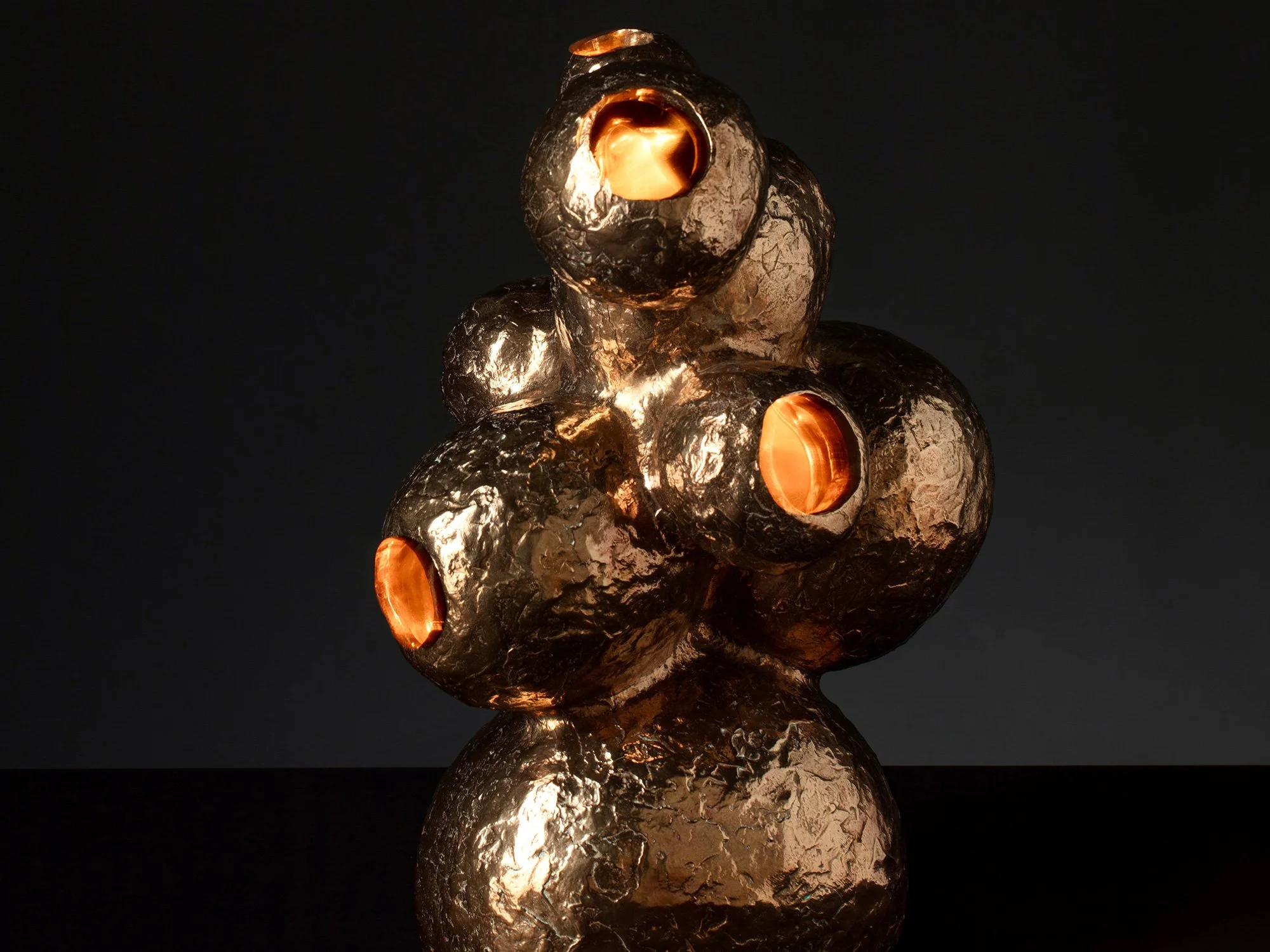 The Rabbithole by Jeske Haak, bronze sculpture with glowing details symbolising a rabbit moving through tunnels.