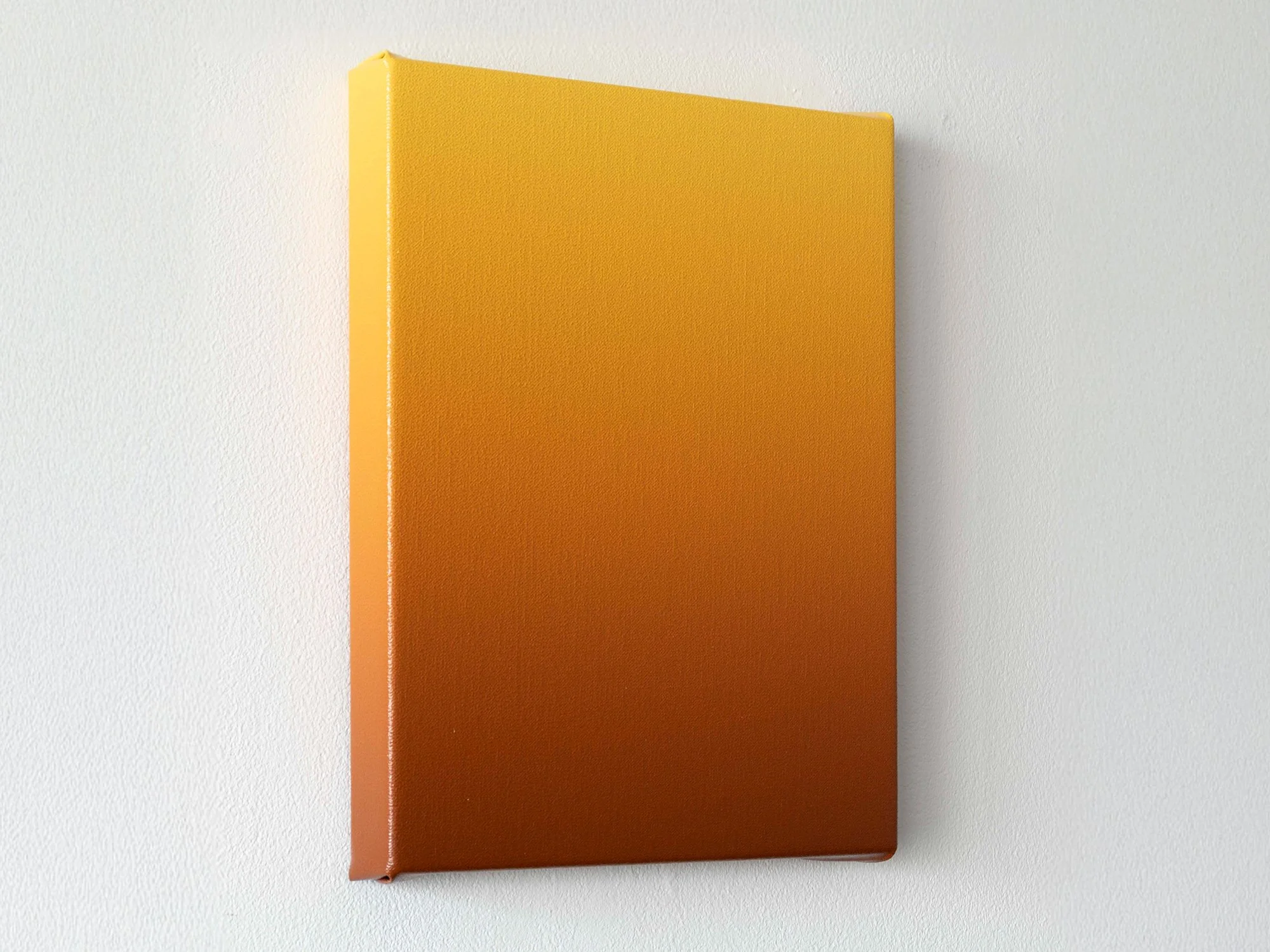 Second side angle of Donald Schenkel’s minimal ochre gradient work, with warm colours visible along the edge.