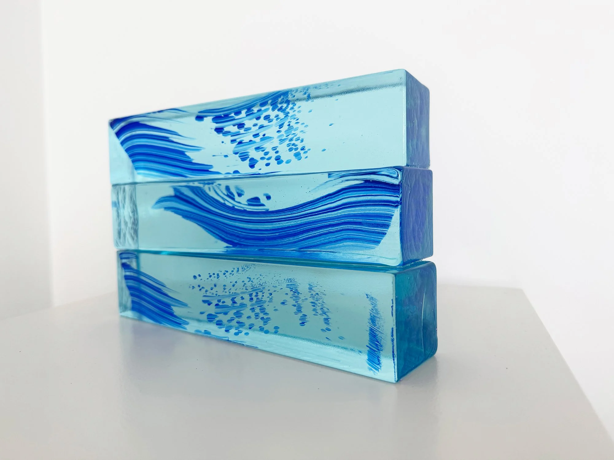 Side view of Spatial Shade I highlighting the brick-like shape and reflective tones