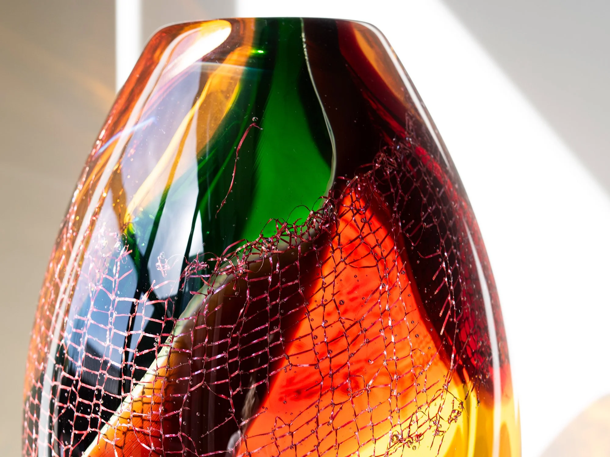 Detail of coloured glass and embedded copper mesh in a sculpture by Francisca Snel