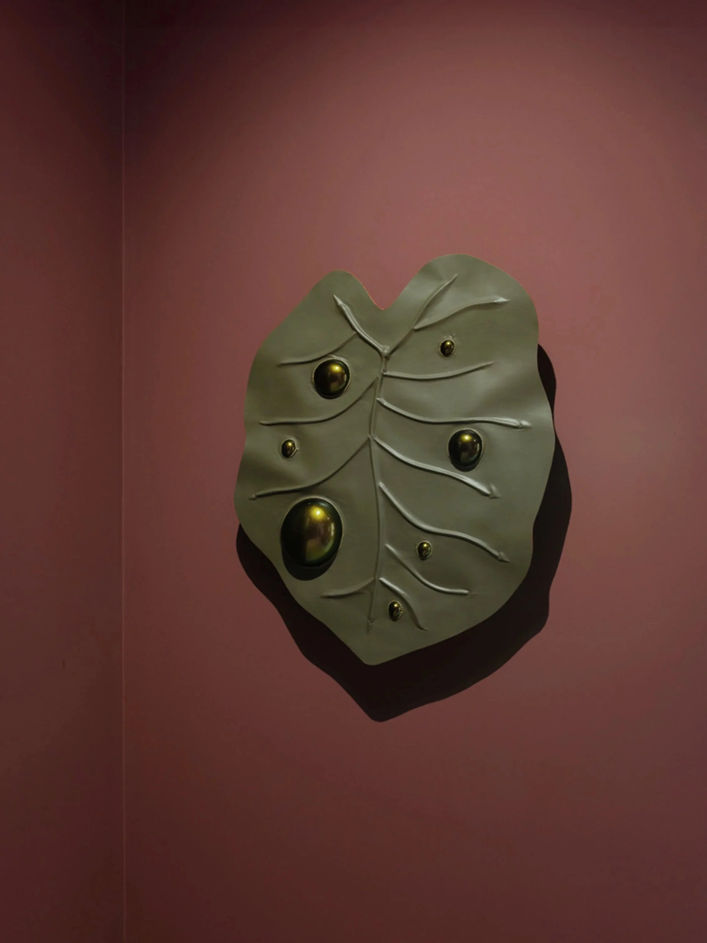 Large contemporary leather wall sculpture by Dutch artist Madelon Uljee, inspired by leaf structures and finished with iridescent details.