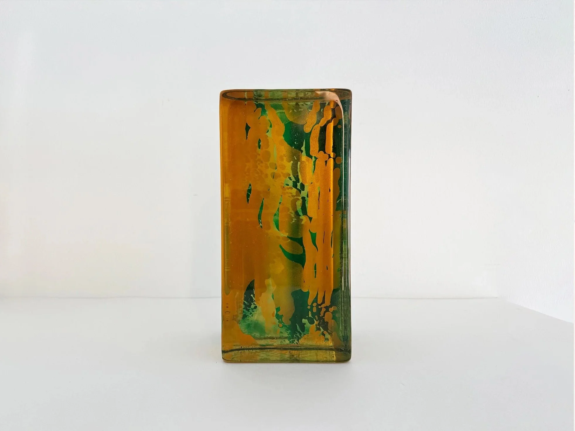 Front view of Spatial Shade glass sculpture by Lisette Schumacher in transparent green and yellow handcast glass