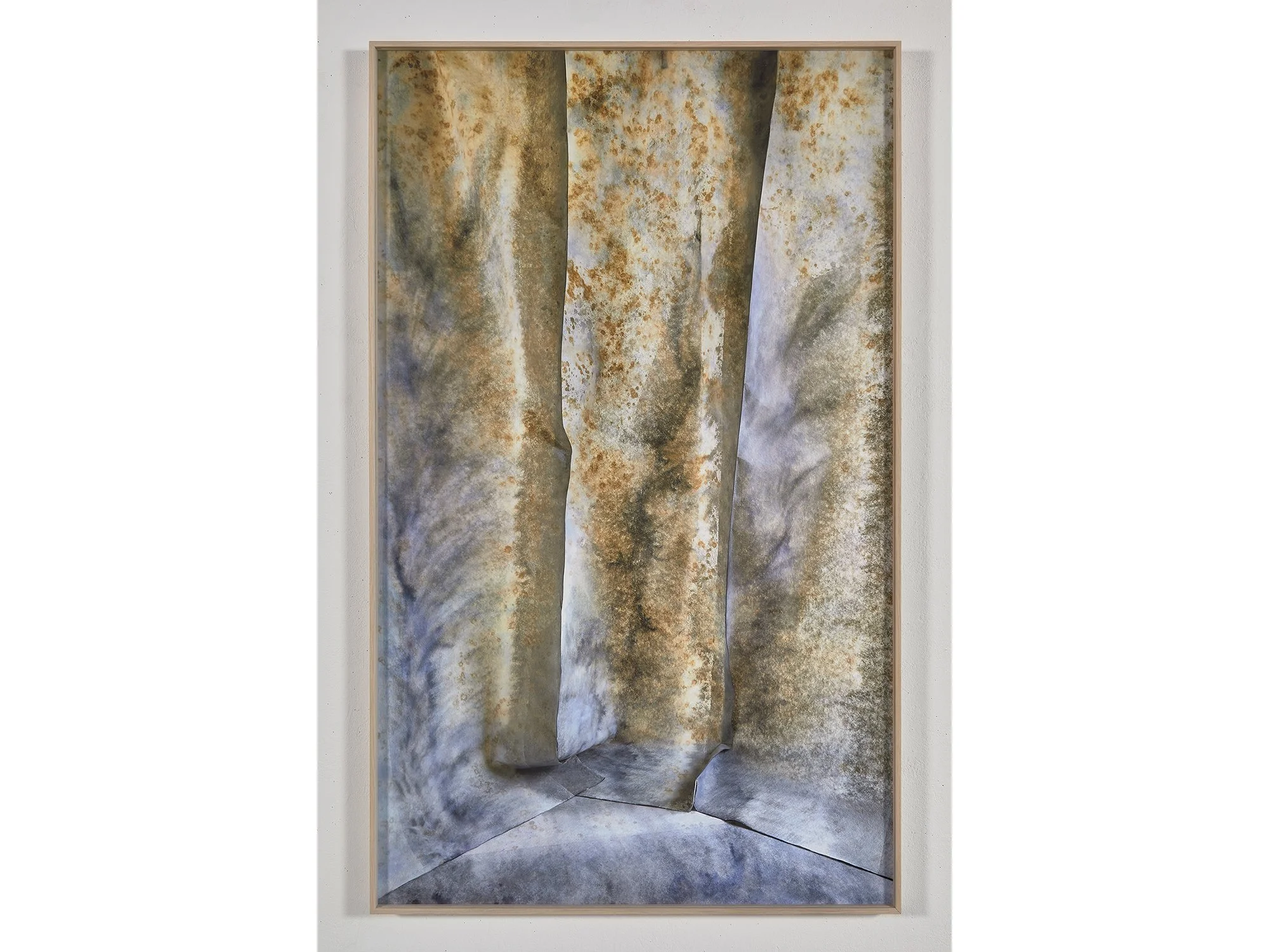Dented Space (2025) by Jan Theun van Rees — framed abstract photograph showing painted fabric walls in gold and blue tones, viewed from the front.