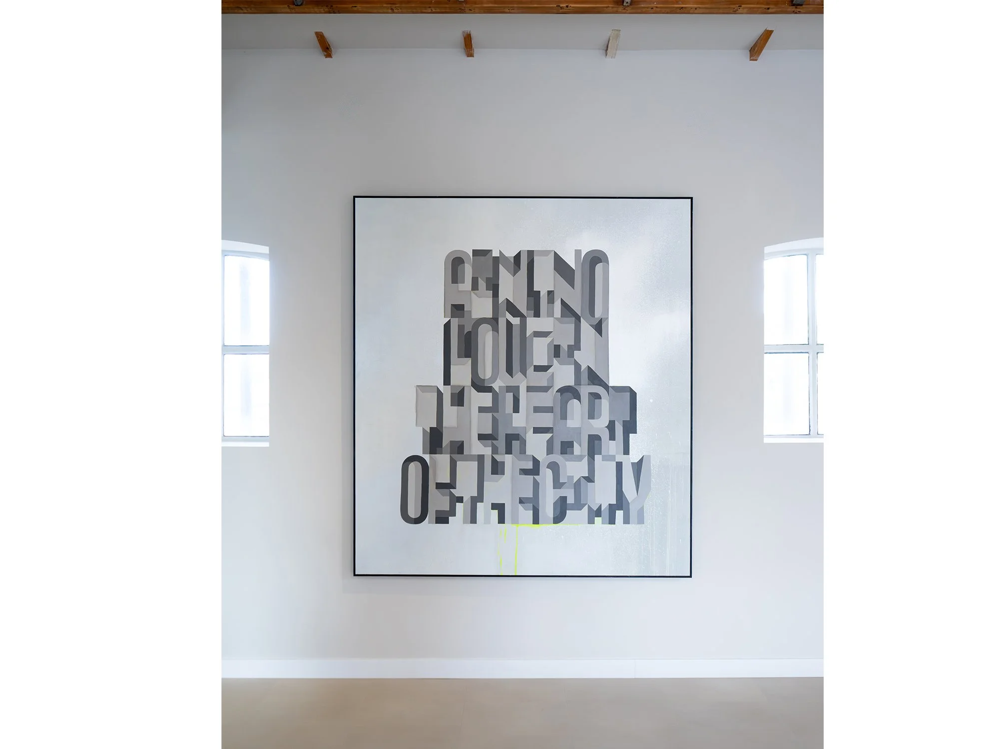 Saïd Kinos’s painting displayed on a gallery wall, its layered grey typography centred between two windows.