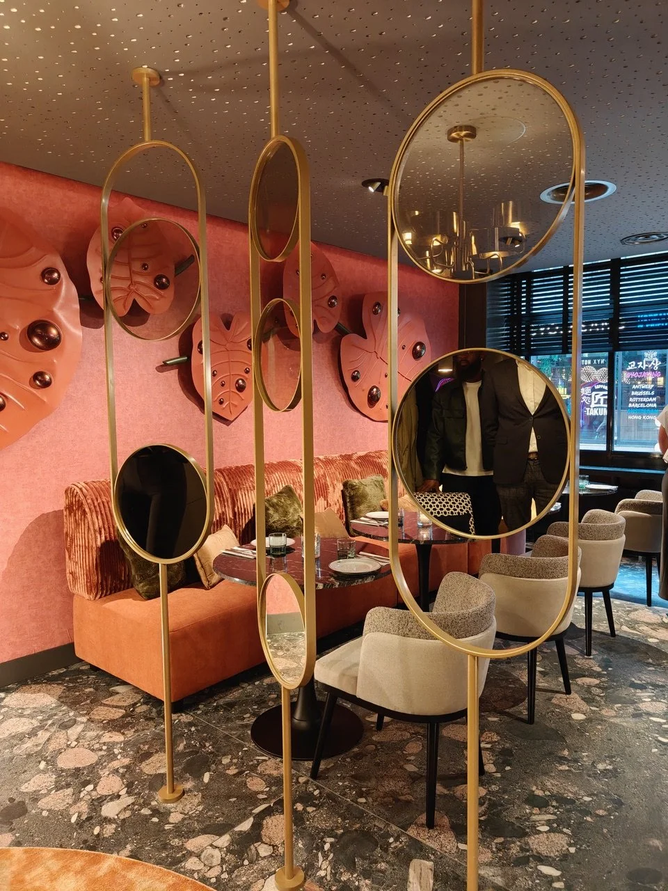 Site-specific leather wall installation by Madelon Uljee in a contemporary hospitality interior, featuring handcrafted sculptural forms inspired by nature.