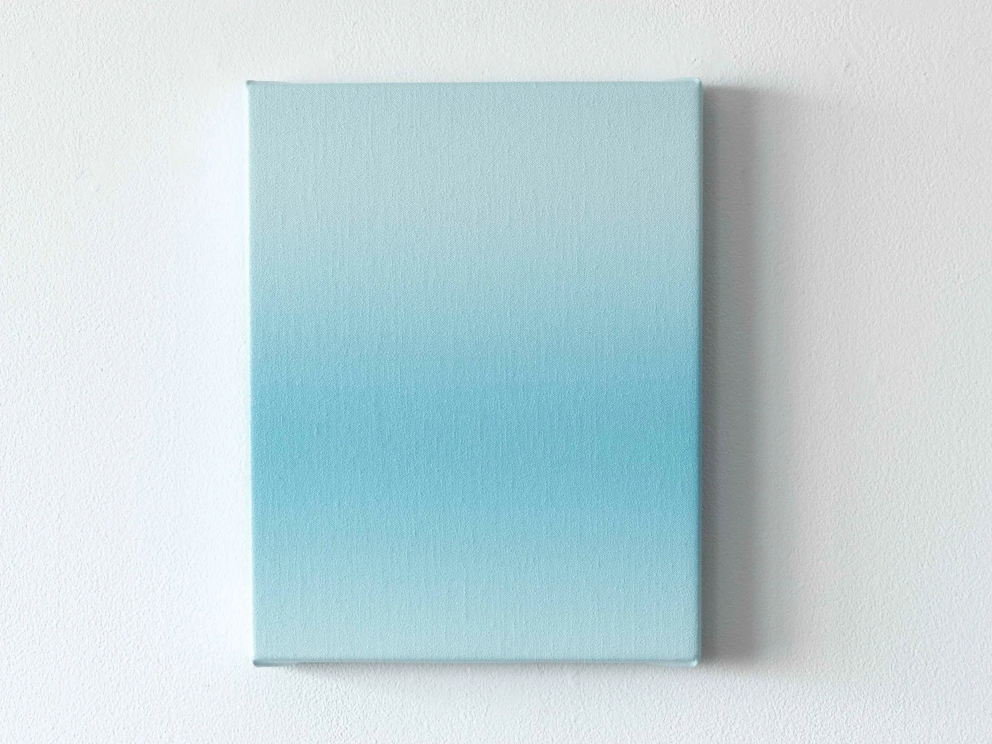 Soft blue gradient painting by Donald Schenkel on a white wall, small format with a subtle painted texture.