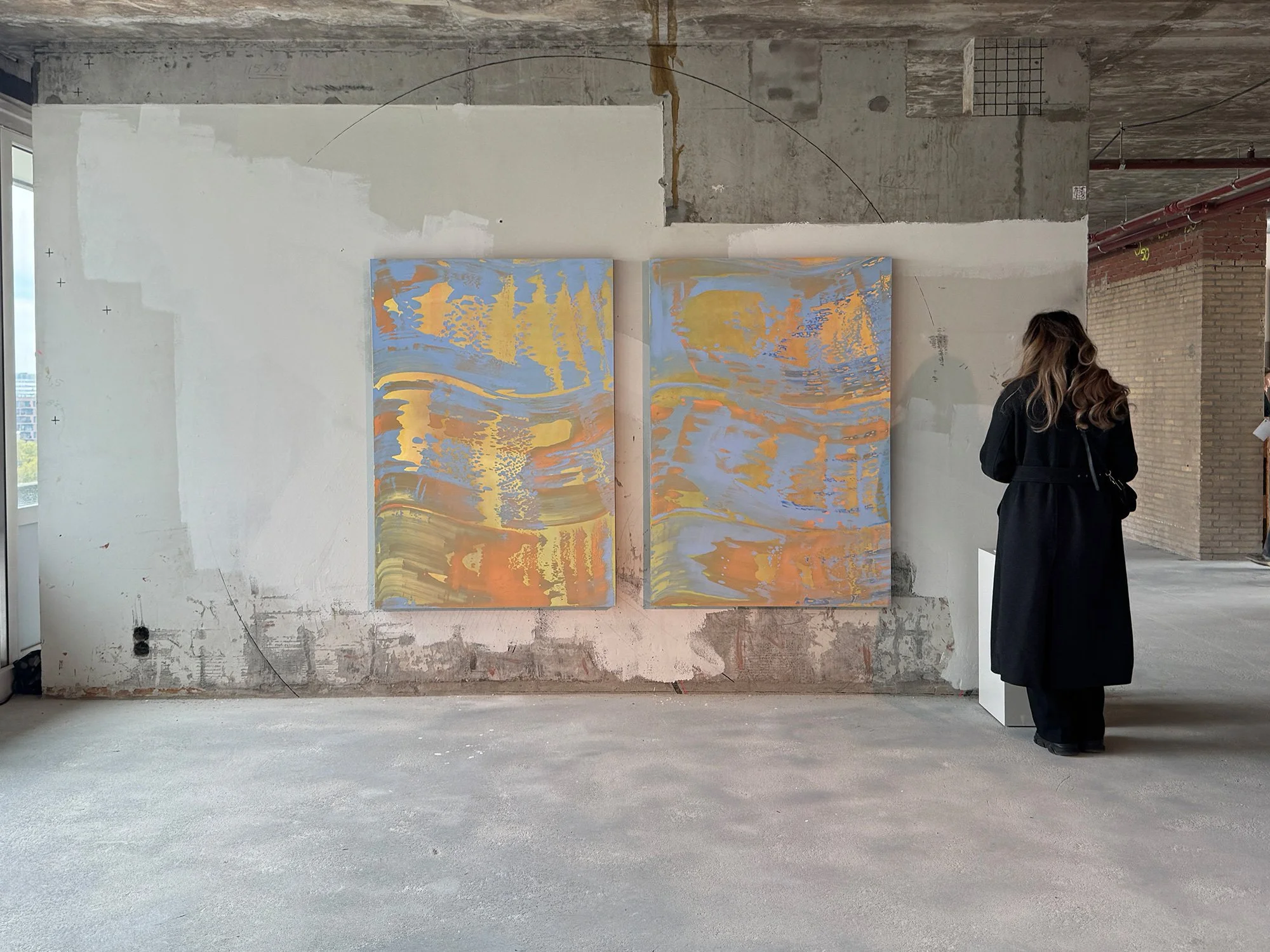 Installation view of two works from The View on Sunset series by Lisette Schumacher in an industrial setting, emphasizing scale, surface texture and atmospheric colour transitions.