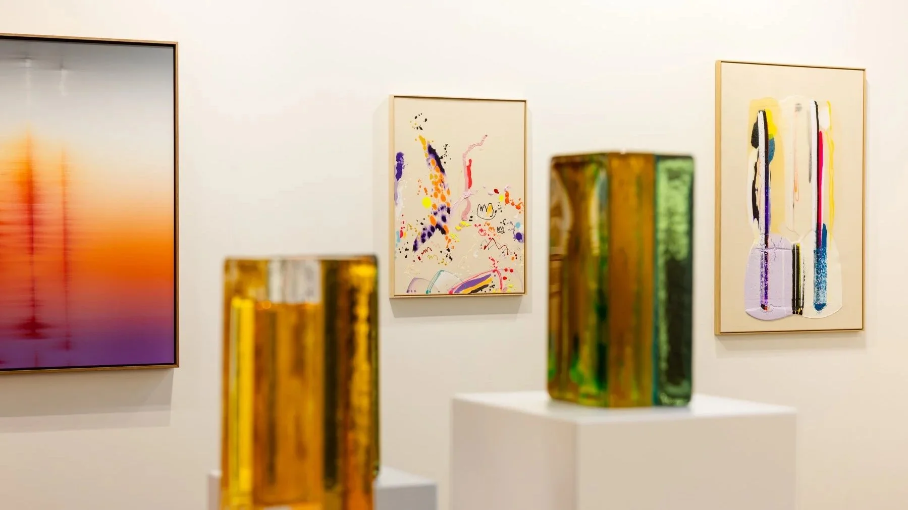 Abstract paintings by Vera Klaus, Donald Schenkel and Karen van de Vliet in the booth of Art Rotterdam, with glass sculptures by Lisette Schumacher in the front.