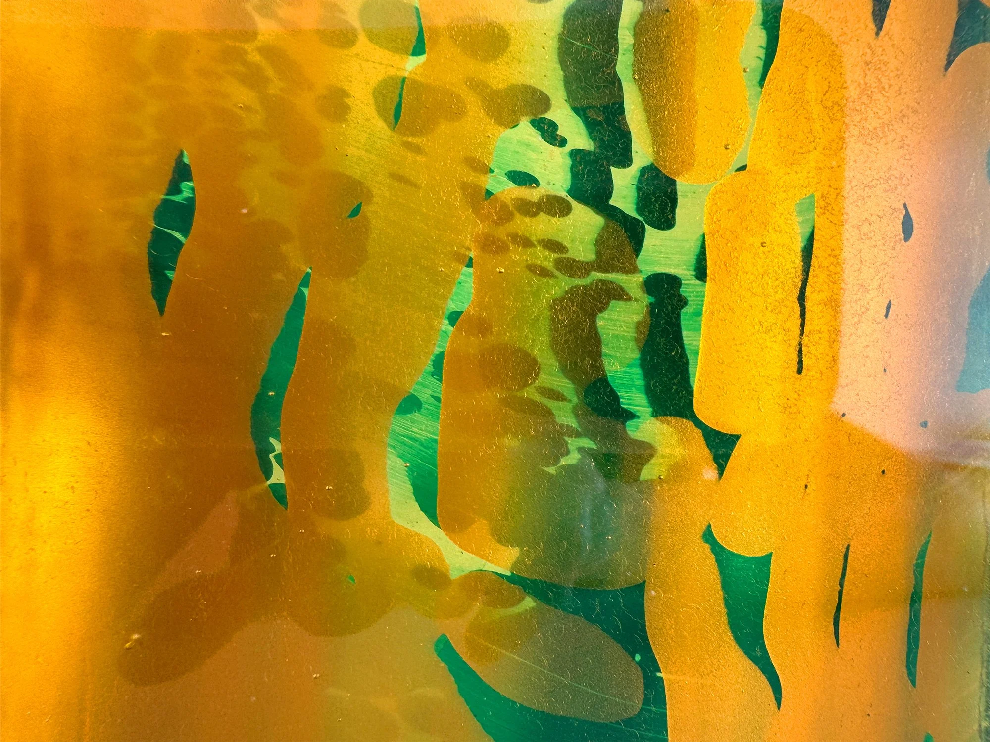 Close-up of Spatial Shade glass sculpture by Lisette Schumacher showing layered green and yellow glass and surface texture