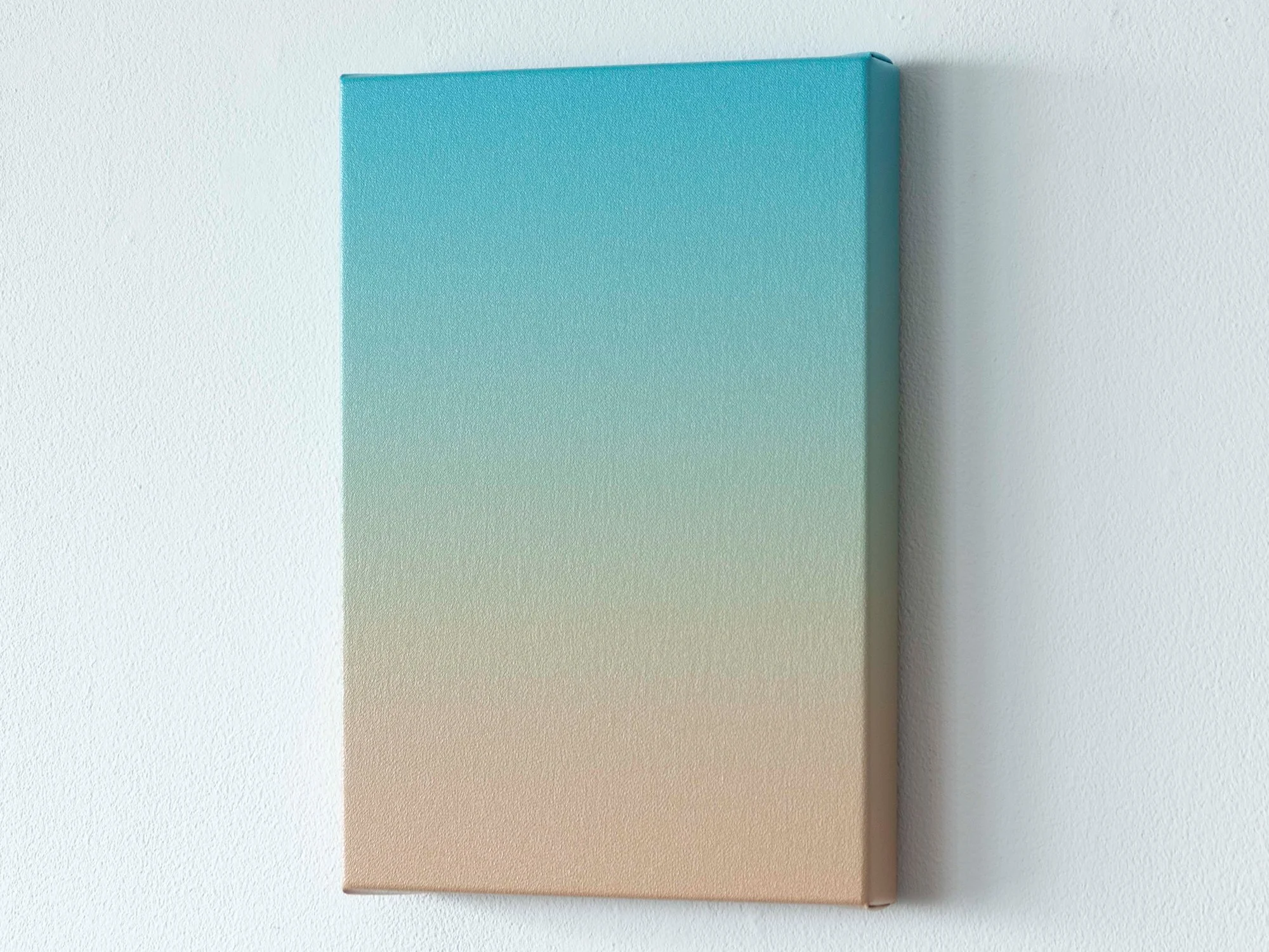 Side angle of Donald Schenkel’s Soft Lagoon painting, showing the canvas depth and gentle colour shift.