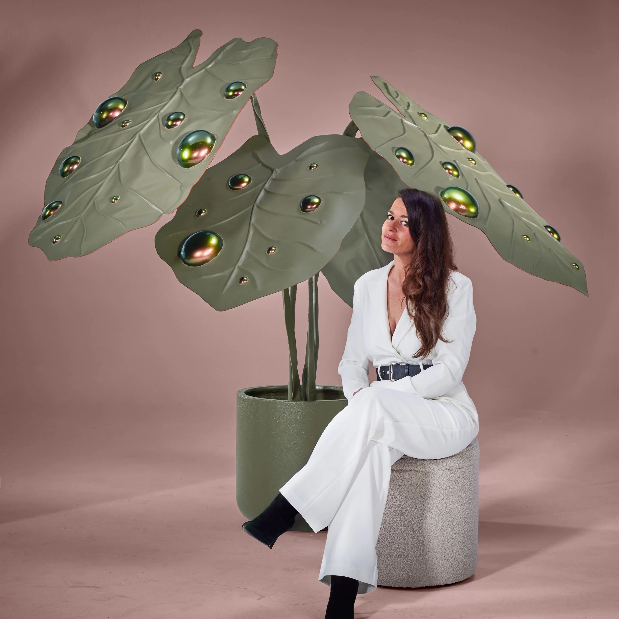 Madelon Uljee with large leather sculpture inspired by leaf structures, contemporary sculptural installation