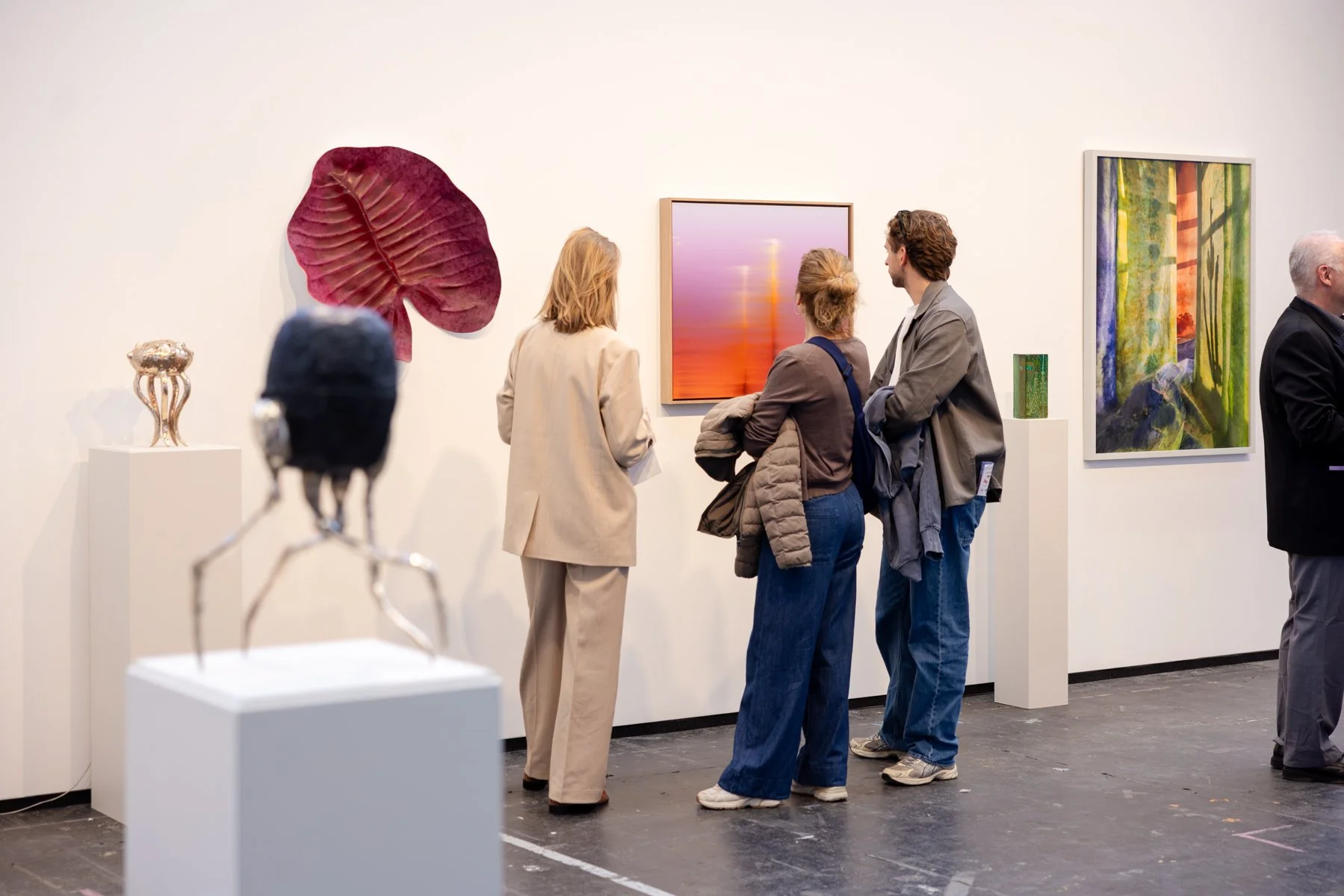 Visitors standing in front of Lights In The Sky by Donald Schenkel at KunstRAI 2026, showing scale and viewing distance