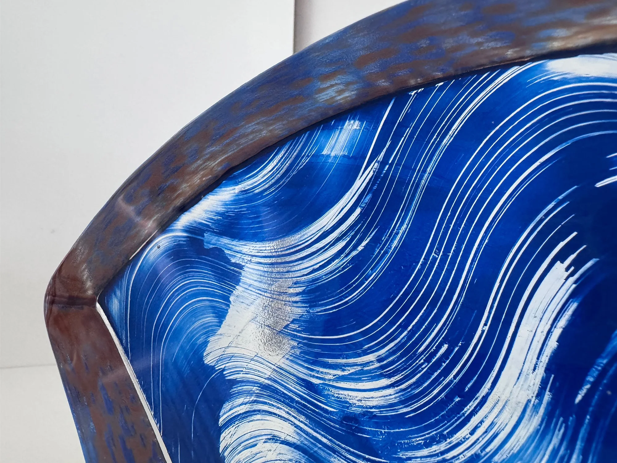Detail of the concave lower edge and blue-and-white composition of Lisette Schumacher’s Spatial Shade Segment I.