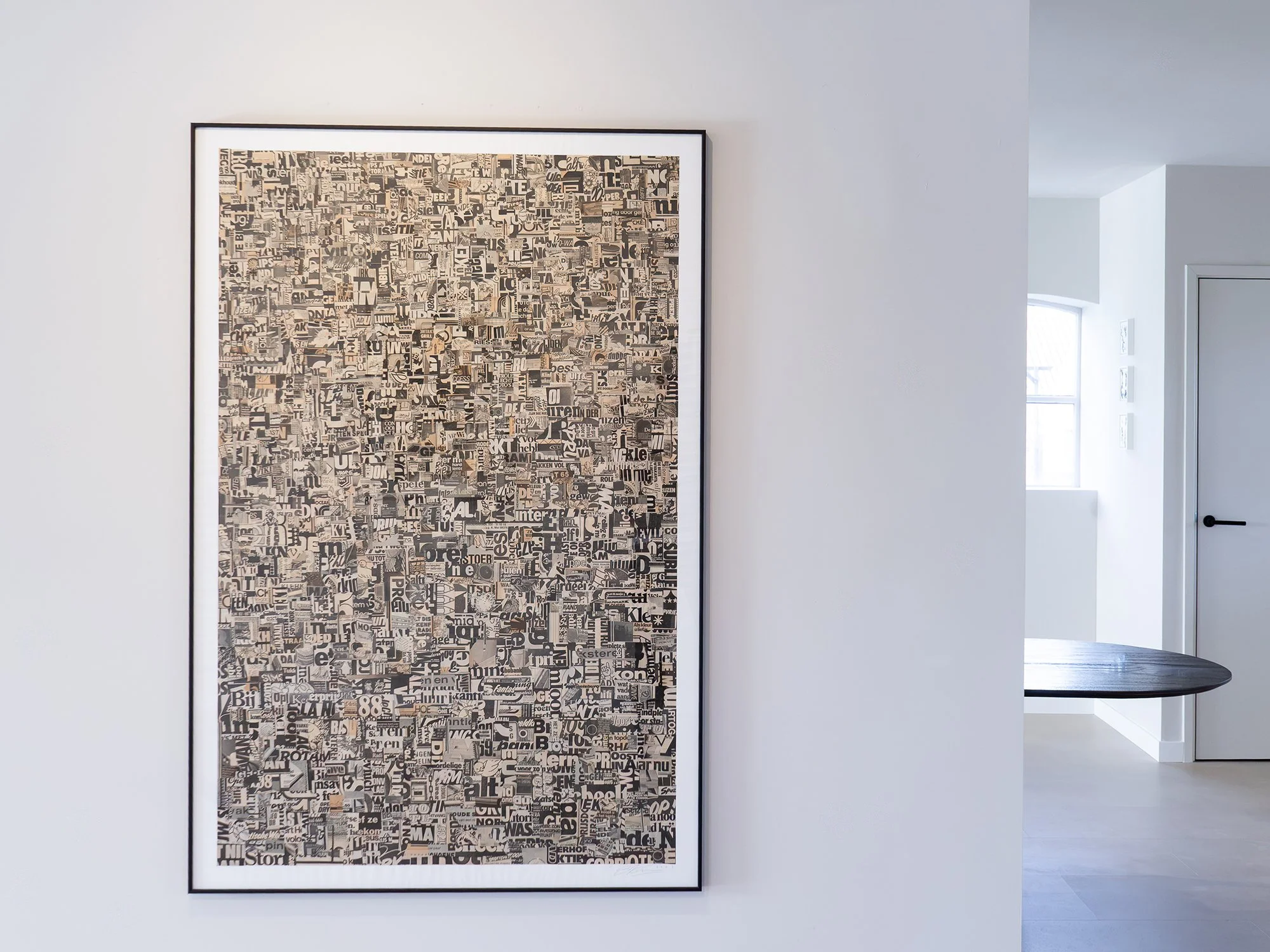 Saïd Kinos’s Static001 displayed on a gallery wall, a large framed collage of printed text fragments.