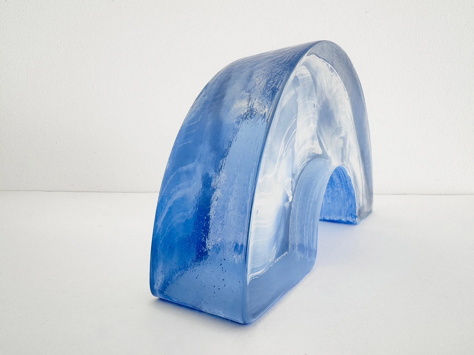 Right side view of Spatial Shade Arch I by Lisette Schumacher, showing its curved profile and translucent blue glass edge.