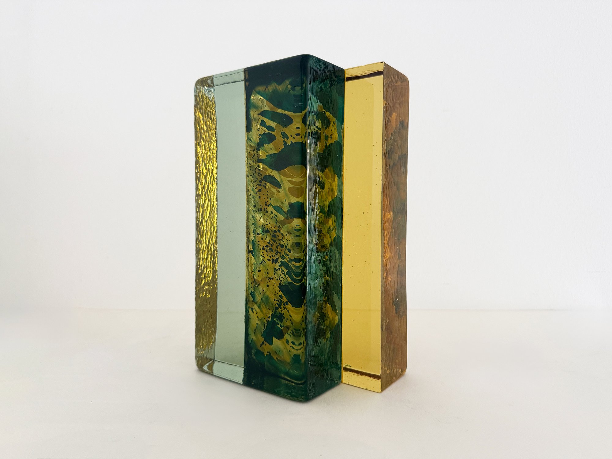 Handcast glass sculpture Spatial Shade IX by Lisette Schumacher in green and yellow transparent glass inspired by architectural brick forms