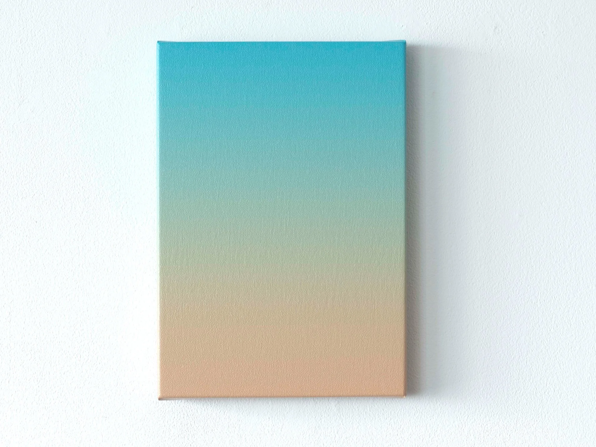 Small blue-to-sand gradient painting by Donald Schenkel on a white wall, showing a soft transition from turquoise to warm beige.