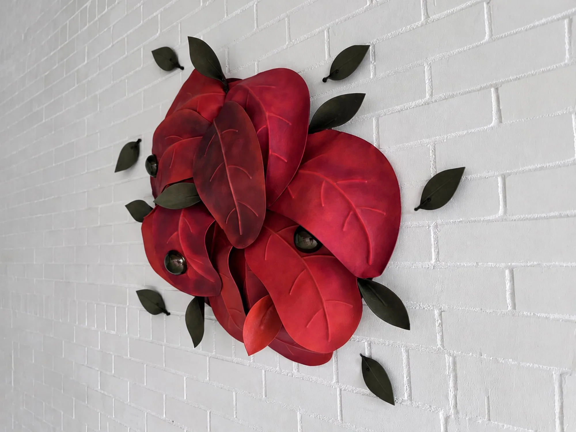 Side view of Madelon Uljee’s After the Storm, showing the depth and curved leather forms of the wall sculpture.