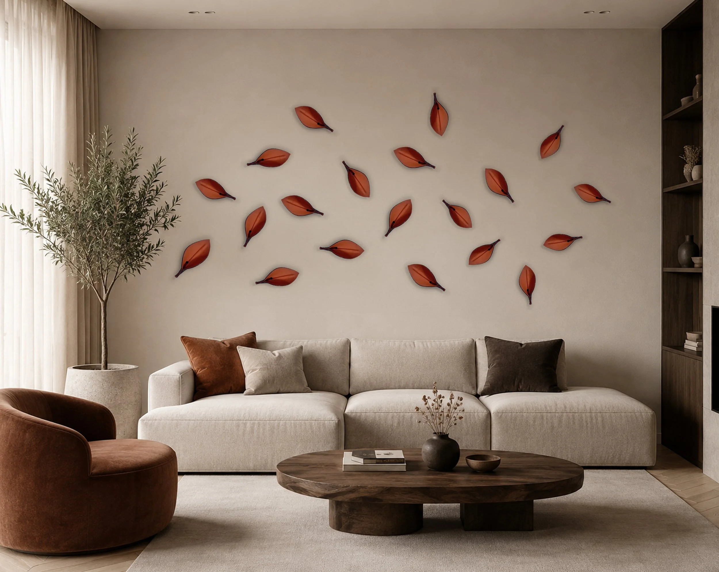 Individual orange leather leaves by Madelon Uljee arranged as a sculptural wall installation in a contemporary interior.