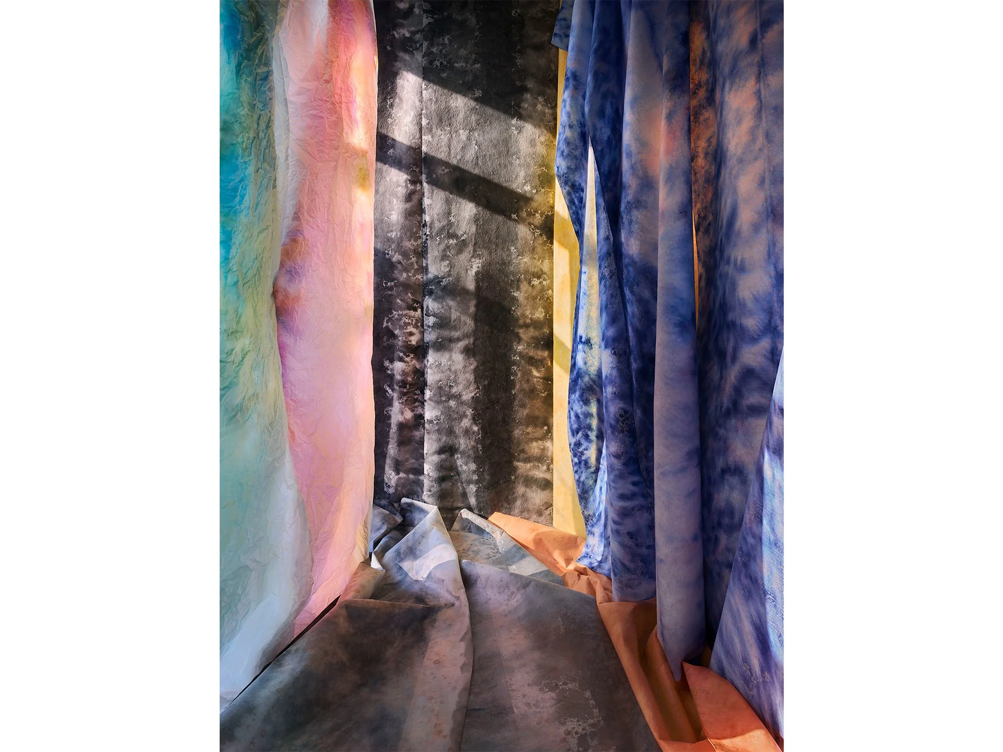 Het licht om de Hoek by Jan Theun van Rees showing draped fabrics in blue, pink and grey within a constructed interior space