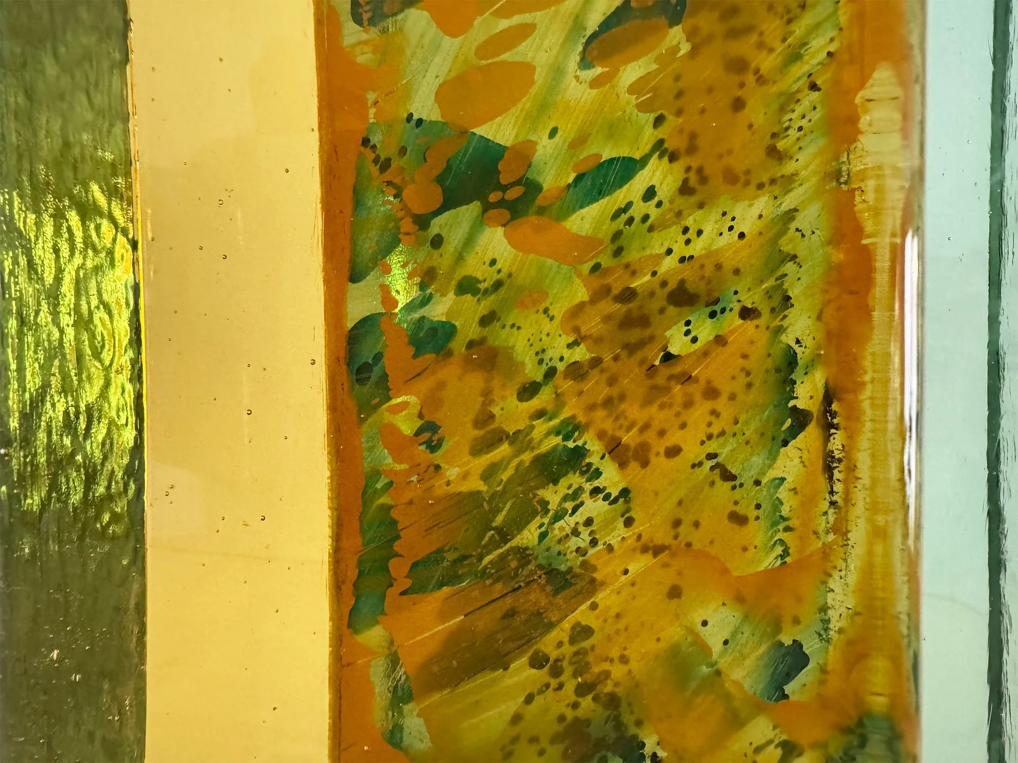 Detail of Spatial Shade IX glass sculpture by Lisette Schumacher showing transparent green glass and internal colour patterns