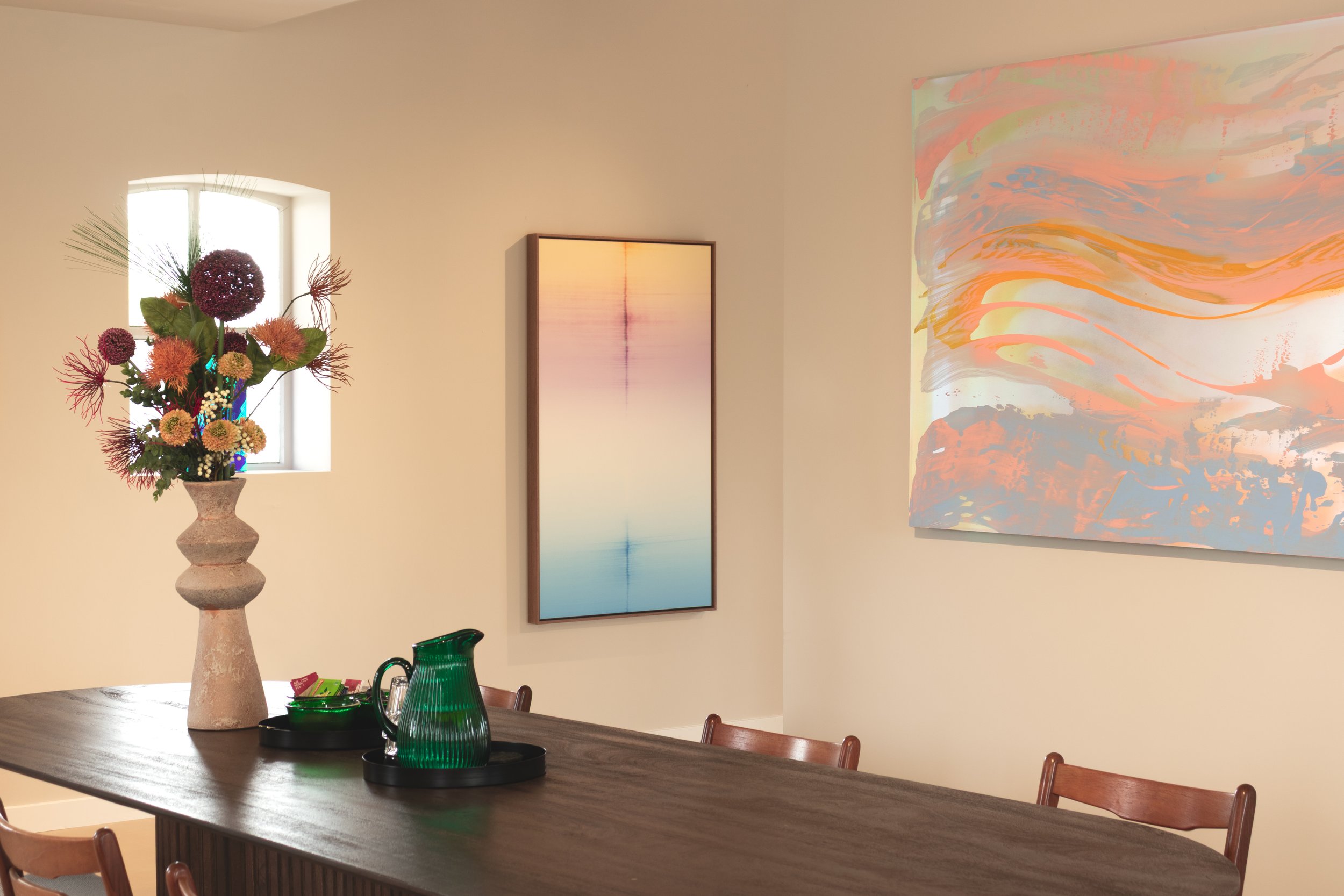 Small group meeting in a gallery space surrounded by contemporary artworks near Rotterdam