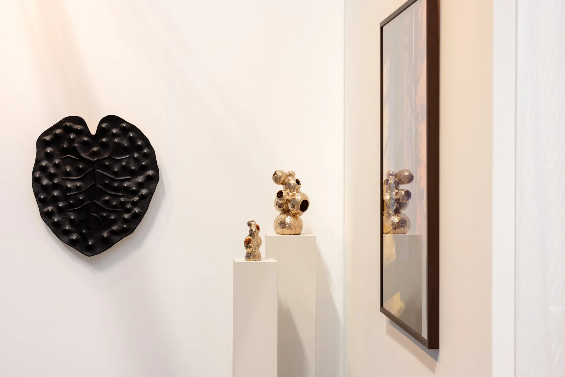 Leaf Bubbles by Madelon Uljee installed on the wall at KunstRAI 2026, showing black leather relief and organic surface structure