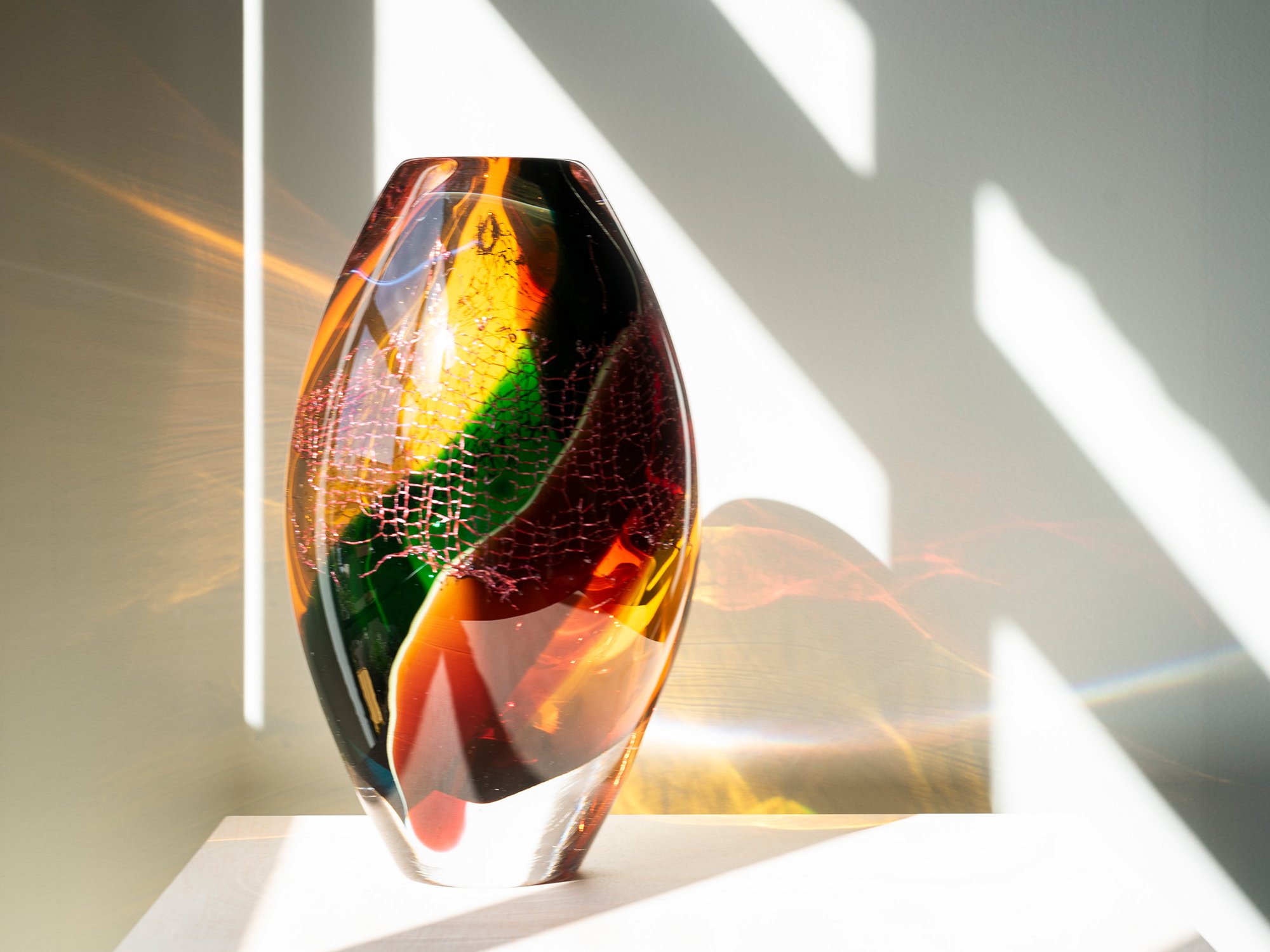 Colourful glass and copper sculpture by Francisca Snel in natural sunlight